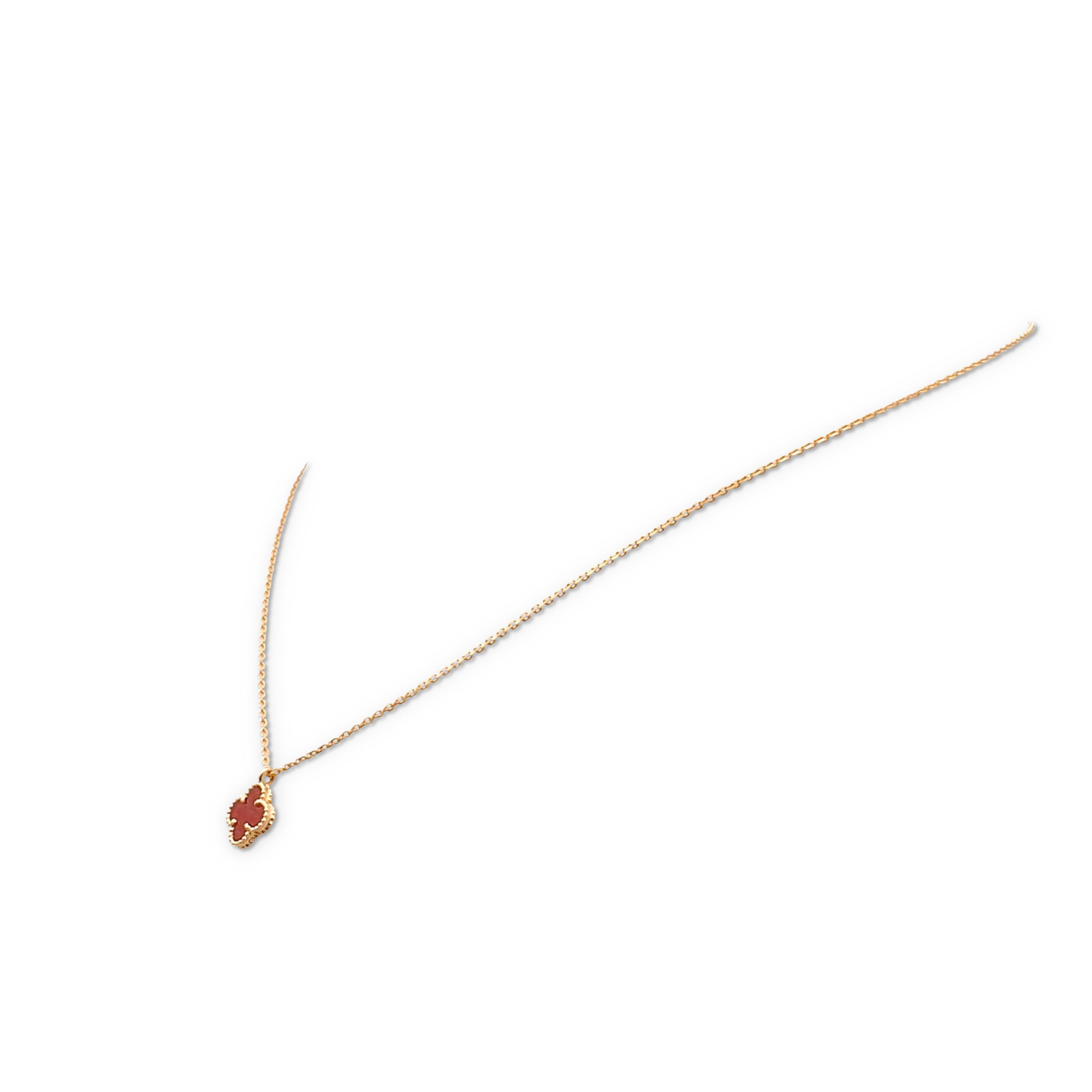 Authentic Van Cleef & Arpels 'sweet' Alhambra pendant necklace crafted in 18 karat rose gold and featuring a single motif pendant in carnelian. The necklace measures 16.5 inches in total length with an adjustable chain.  The pendant measures 4mm x