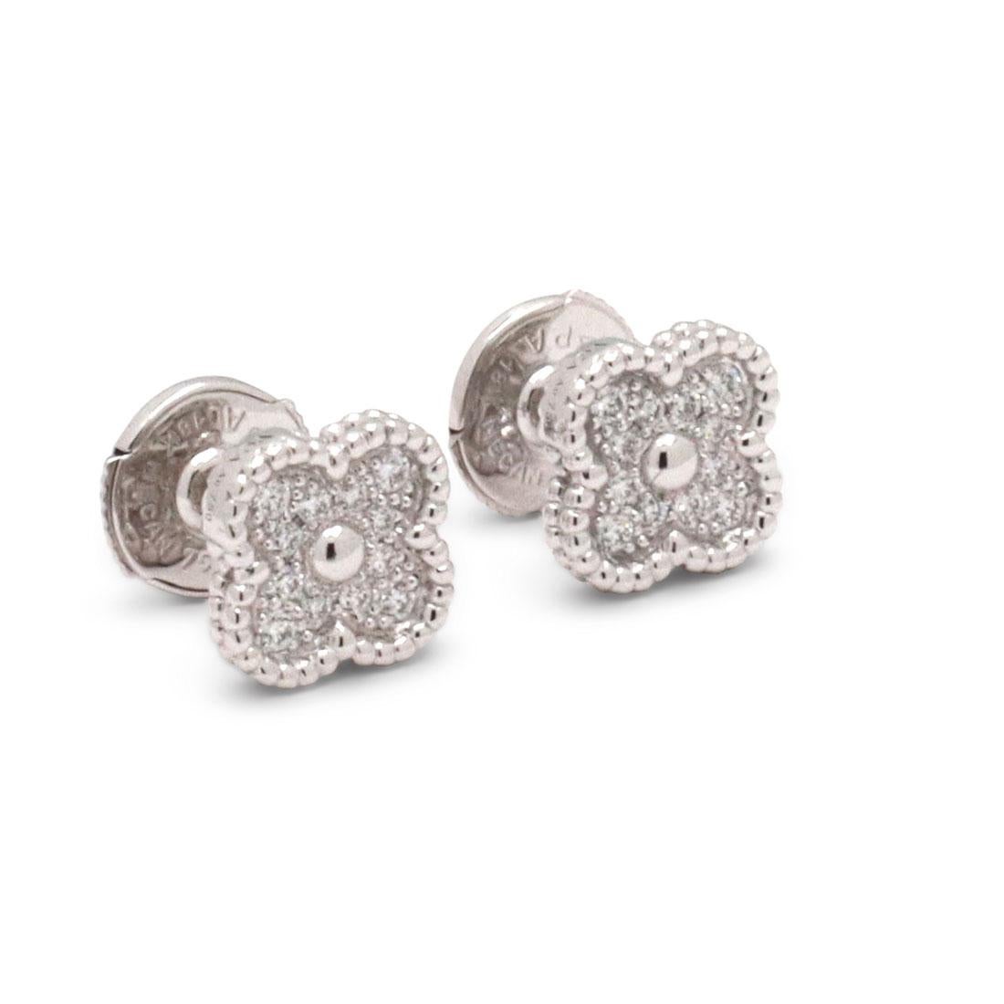 Authentic Van Cleef & Arpels 'Sweet Alhambra' earrings crafted in 18 karat white gold centering on a clover motif set with an estimated 0.16 carats total of round brilliant cut diamonds (E-F color, VS clarity). Signed VCA, Au750, with serial number