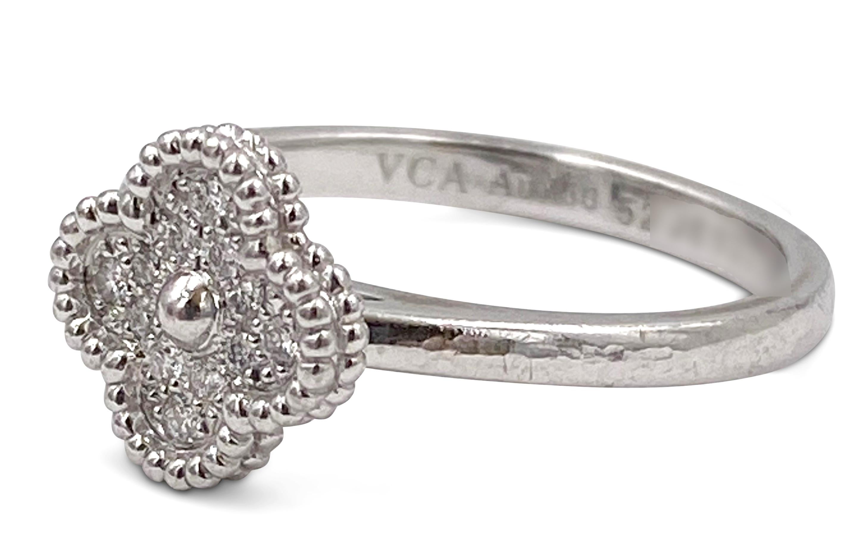 Authentic Van Cleef & Arpels 'Sweet' Alhambra' ring crafted in 18 karat white gold and set with an estimated 0.12 carats of round brilliant cut diamonds (F-G color, VS clarity).  The clover motif measures approx. 9mm x 9mm. Ring size 6. Signed VCA,