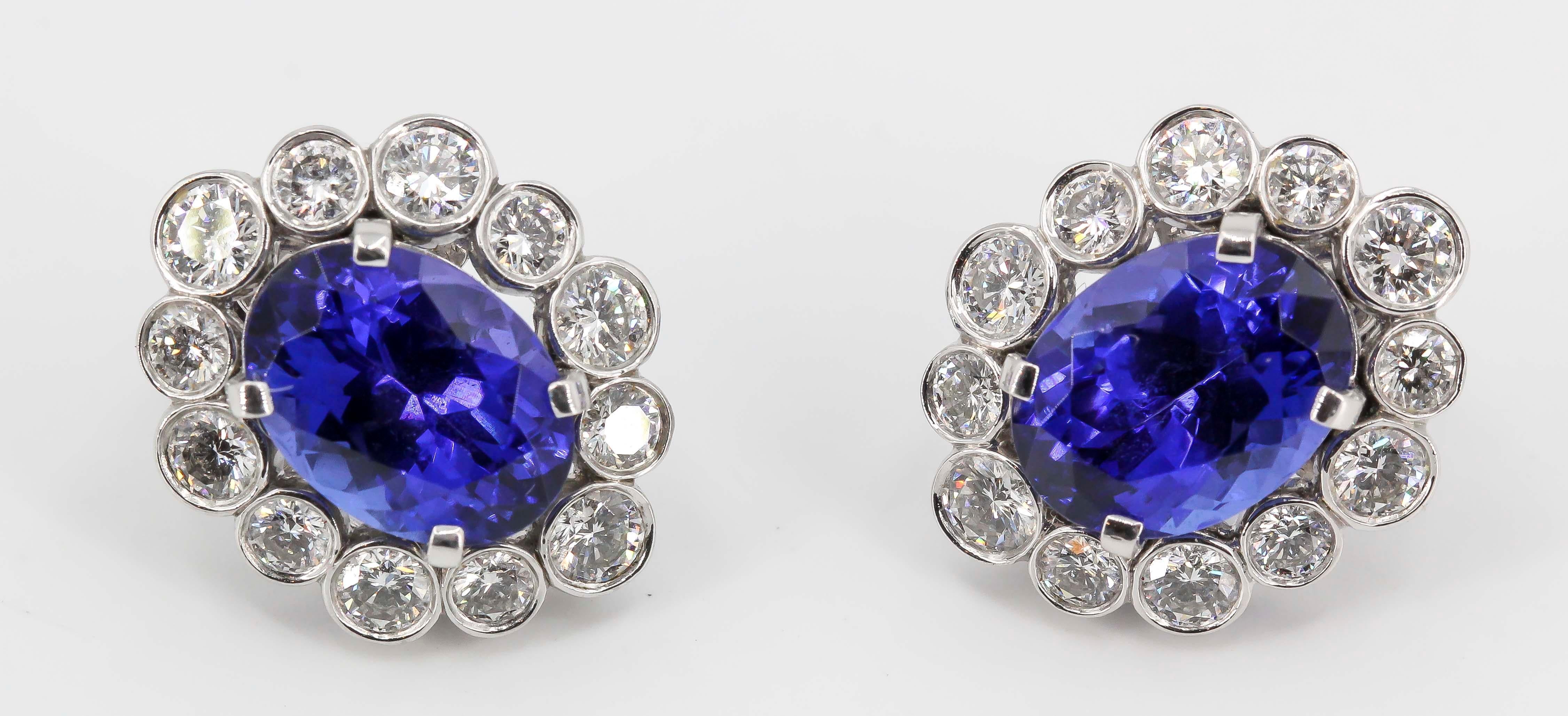 Elegant tanzanite, diamond and platinum earrings by Van Cleef & Arpels, circa 1970s. They feature a large blue tanzanite in the middle, surrounded by high grade round brilliant cut diamonds over a platinum setting. 

Hallmarks: Van Cleef & Arpels,