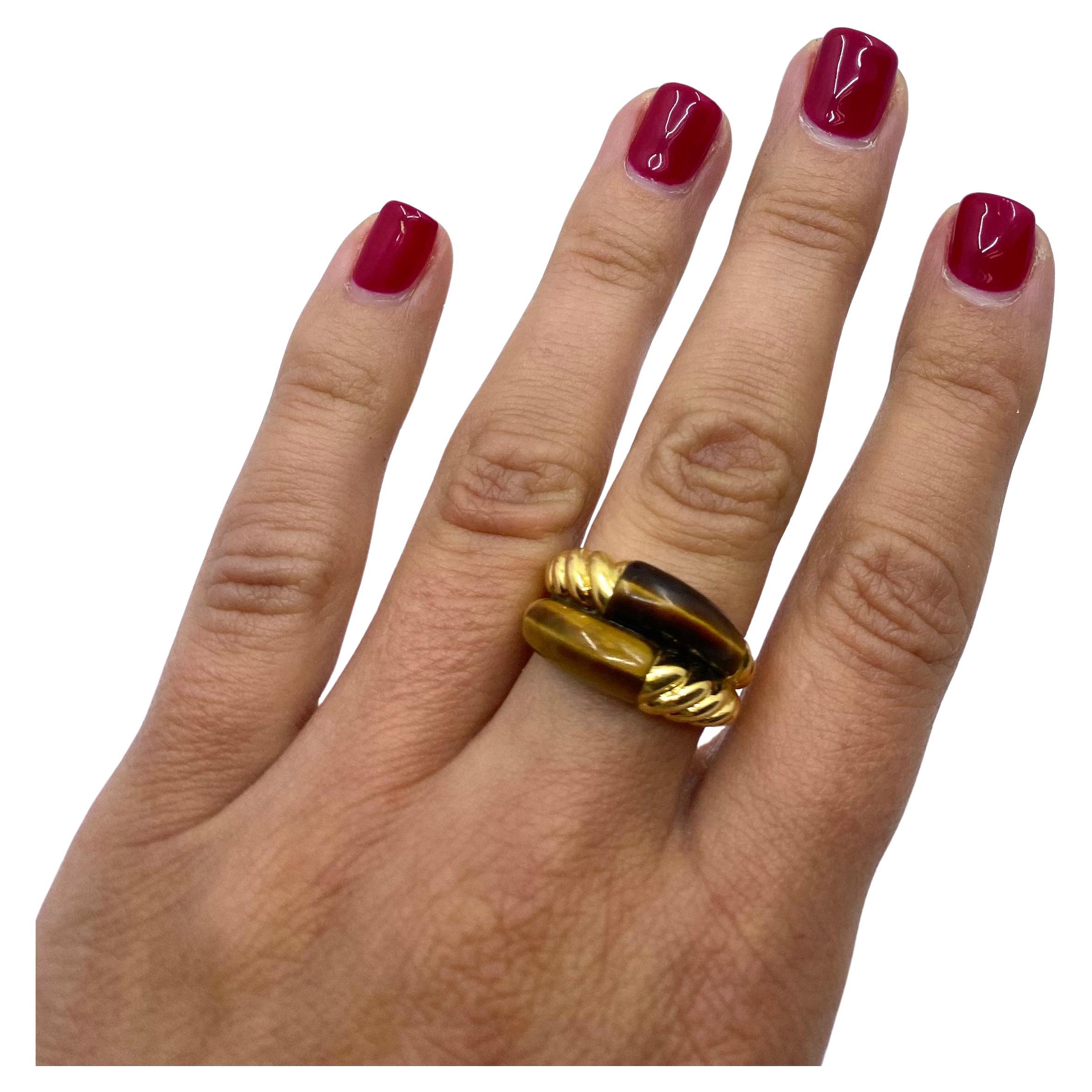 A unique vintage ring by Van Cleef & Arpels made of 18k gold and a tiger’s eye. The ring perfectly displays a gorgeous luster of the tiger’s eye. The gem’s glossy beauty is enhanced with a polished gold swirl element which is a distinctive feature