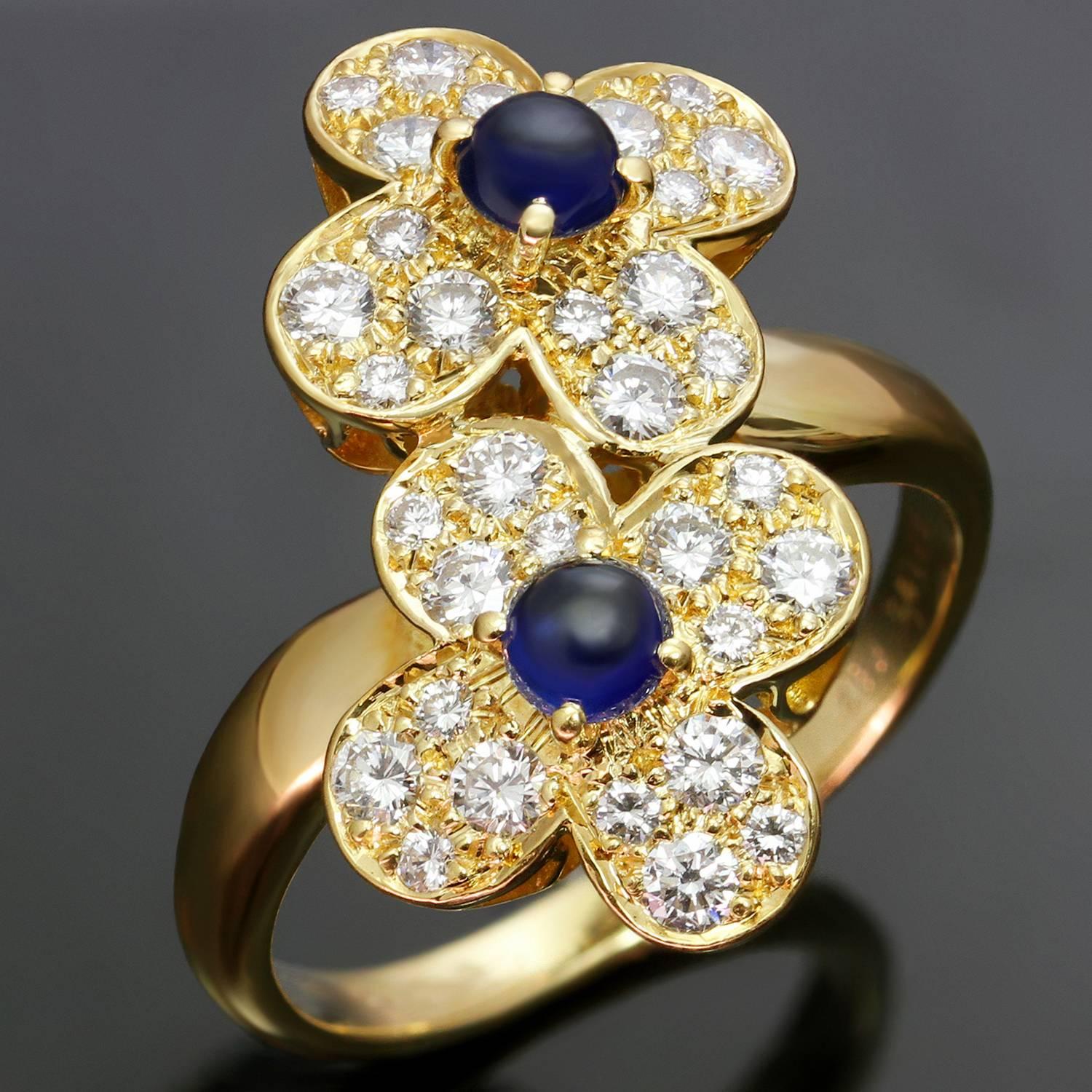 This stunning Van Cleefs & Arpels ring from the classic Trefle collection is crafted in 18k yellow gold and features a double clover flower motif set with round cabochon sapphire of an estimated 0.65 carats and brilliant-cut round diamonds of 0.80