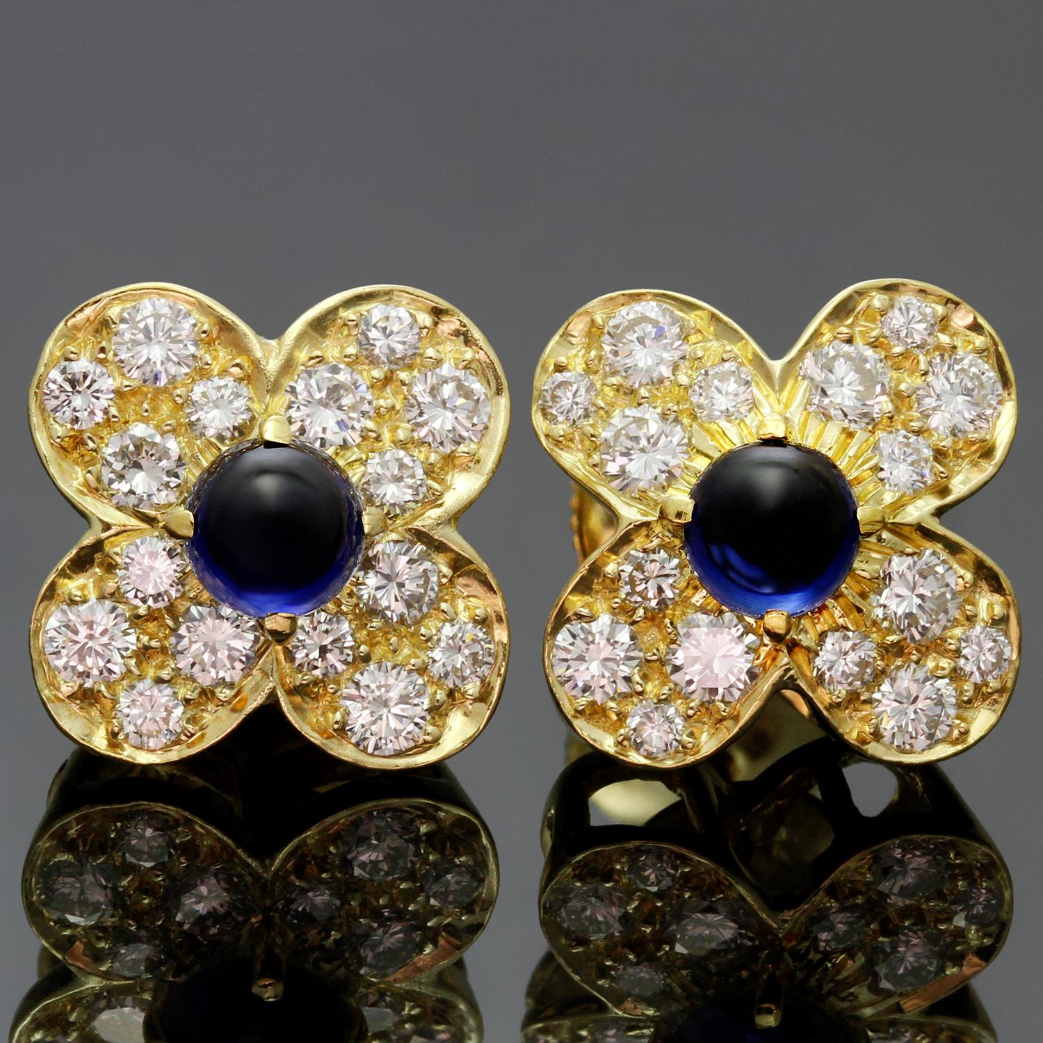 These gorgeous Van Cleefs & Arpels earrings from the classic Trefle collection are crafted in 18k yellow gold and feature 0.90 carats of superb quality brilliant-cut diamonds and 0.80 carats of lustrous blue cabochon sapphires. Earrings are in great