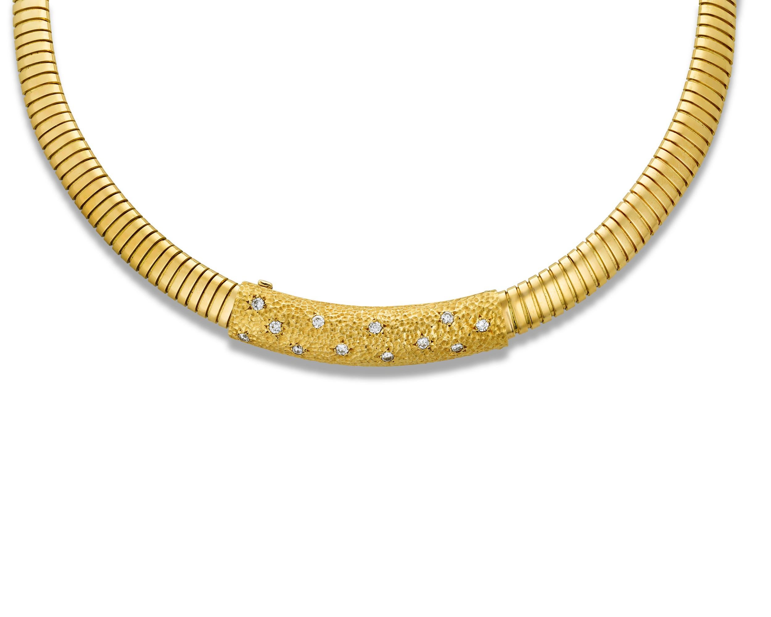 This exceptional Van Cleef & Arpels necklace is a wonder of retro design. This necklace is comprised of a revolutionary, flexible Tubogas link chain of 18K yellow gold. Slightly raised round white diamonds accent the center textured gold panel,