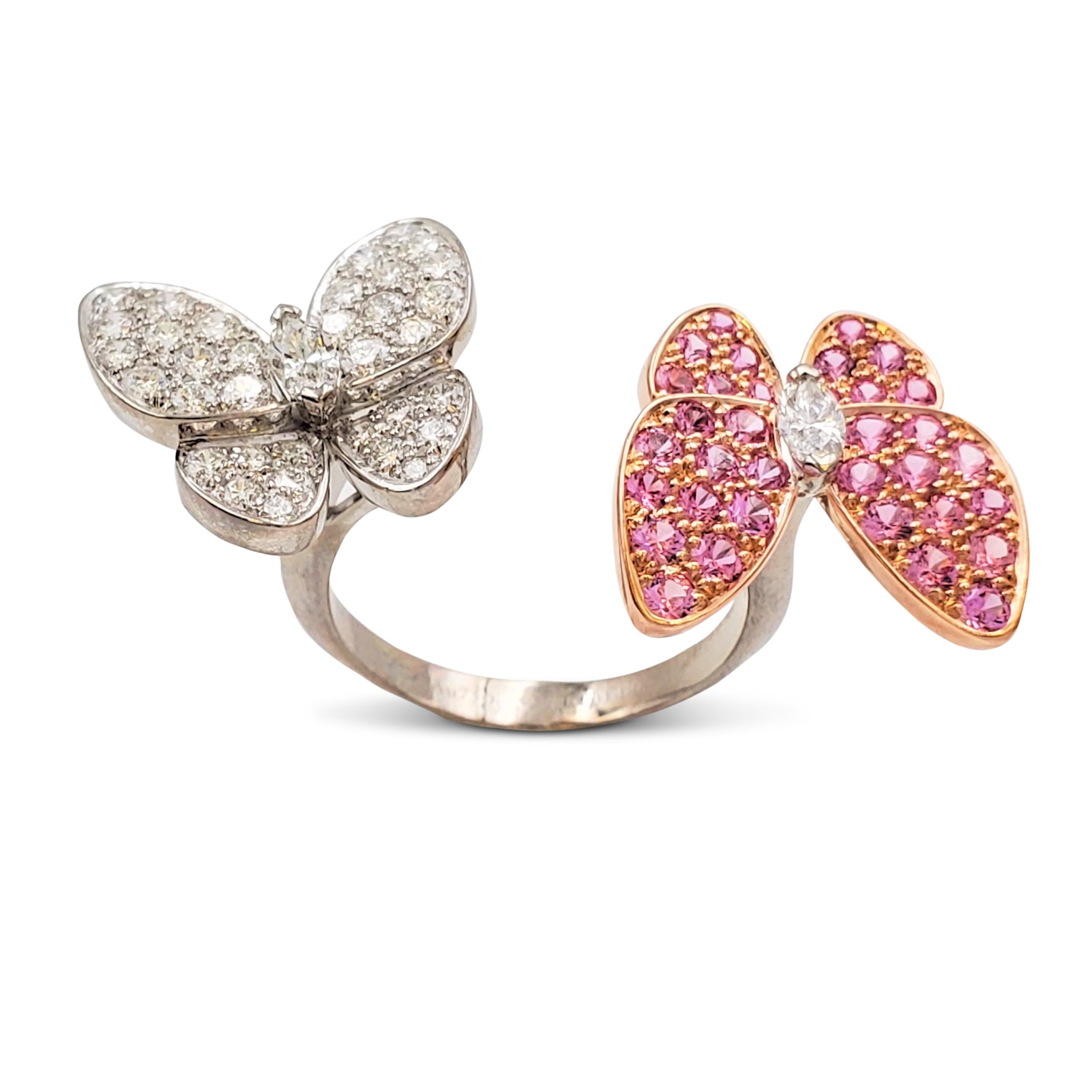 Authentic Van Cleef & Arpels 'Two Butterfly' between-the-finger ring crafted 18 karat white gold features two butterflies that combine color and asymmetry in a dazzling way. The ring is set with an estimated 0.99 carats of high-quality round