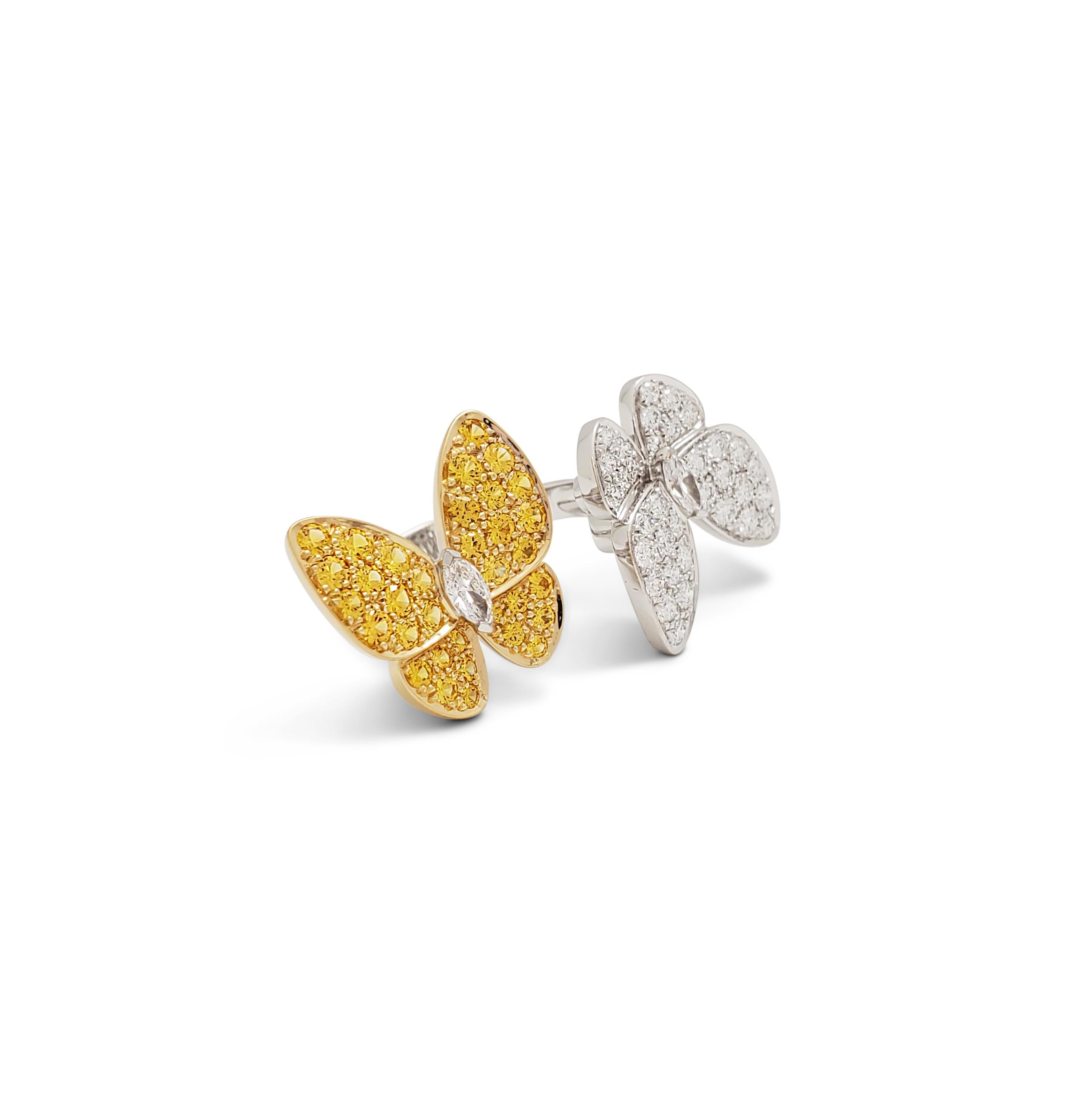 Authentic Van Cleef & Arpels 'Two Butterfly' between-the-finger ring crafted 18 karat white gold features two butterflies that combine color and asymmetry in a dazzling way. The ring is set with an estimated 0.99 carats of high-quality round and