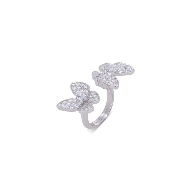 Authentic Van Cleef & Arpels Two Butterfly ring crafted in 18 karat white gold and set with an estimated 1.67 carats of high-quality diamonds.  The whimsical asymmetrical design allows the butterflies to sit between the fingers.  Size 52, US 6. 