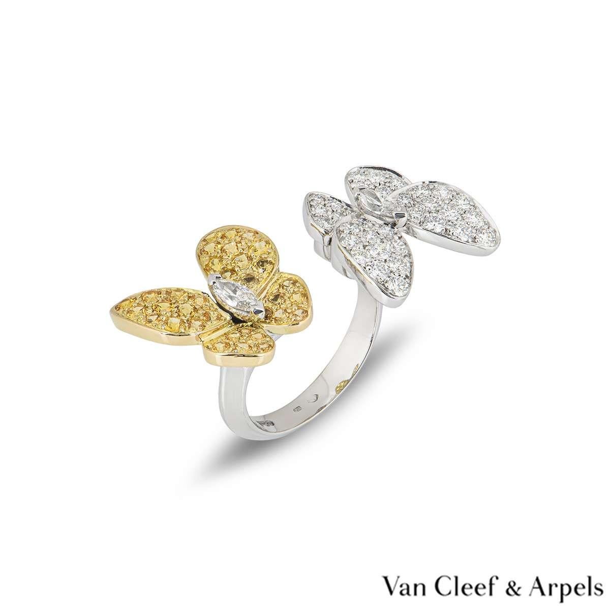 An 18k white gold Two Butterfly Between the Finger ring from the Fauna collection by Van Cleef & Arpels. The ring features two butterfly motifs facing opposite directions, one is set with round brilliant cut diamonds and the other is set with yellow