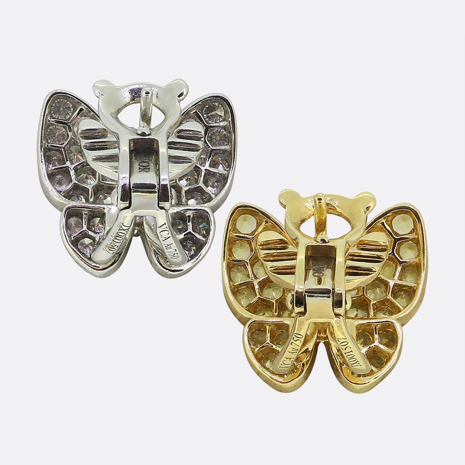 Here we have an exquisite pair of cluster earrings from the world renowned luxury jewellery house of Van Cleef & Arpels. Each piece showcases a graceful butterfly design, adorned with a multitude of white diamonds and yellow sapphires. The wings are