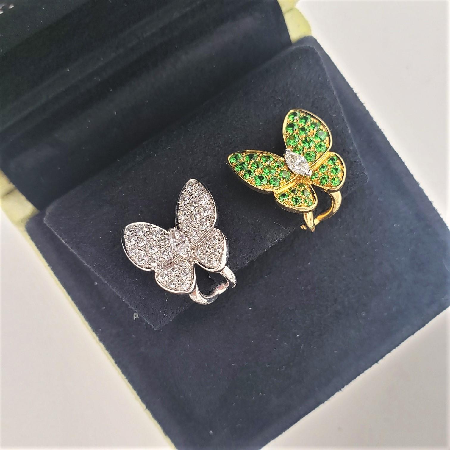 Authentic Van Cleef & Arpels 'Two Butterfly' earrings crafted in 18 karat yellow and white gold combine color and asymmetry in a dazzling way. One earring is crafted in white gold and set with an estimated 1.00 carats of high-quality diamonds. The