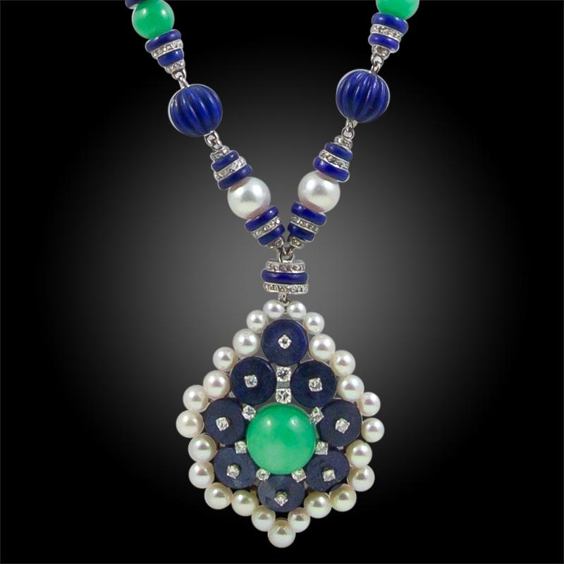 Designed in the 1930's, this VCA pendant necklace is beautifully made with 14 fluted lapis lazuli beads, spaced by eight cultured pearls and further set with six Jadeite jade beads. decorated with lapis lazuli rondelles set at intervals with