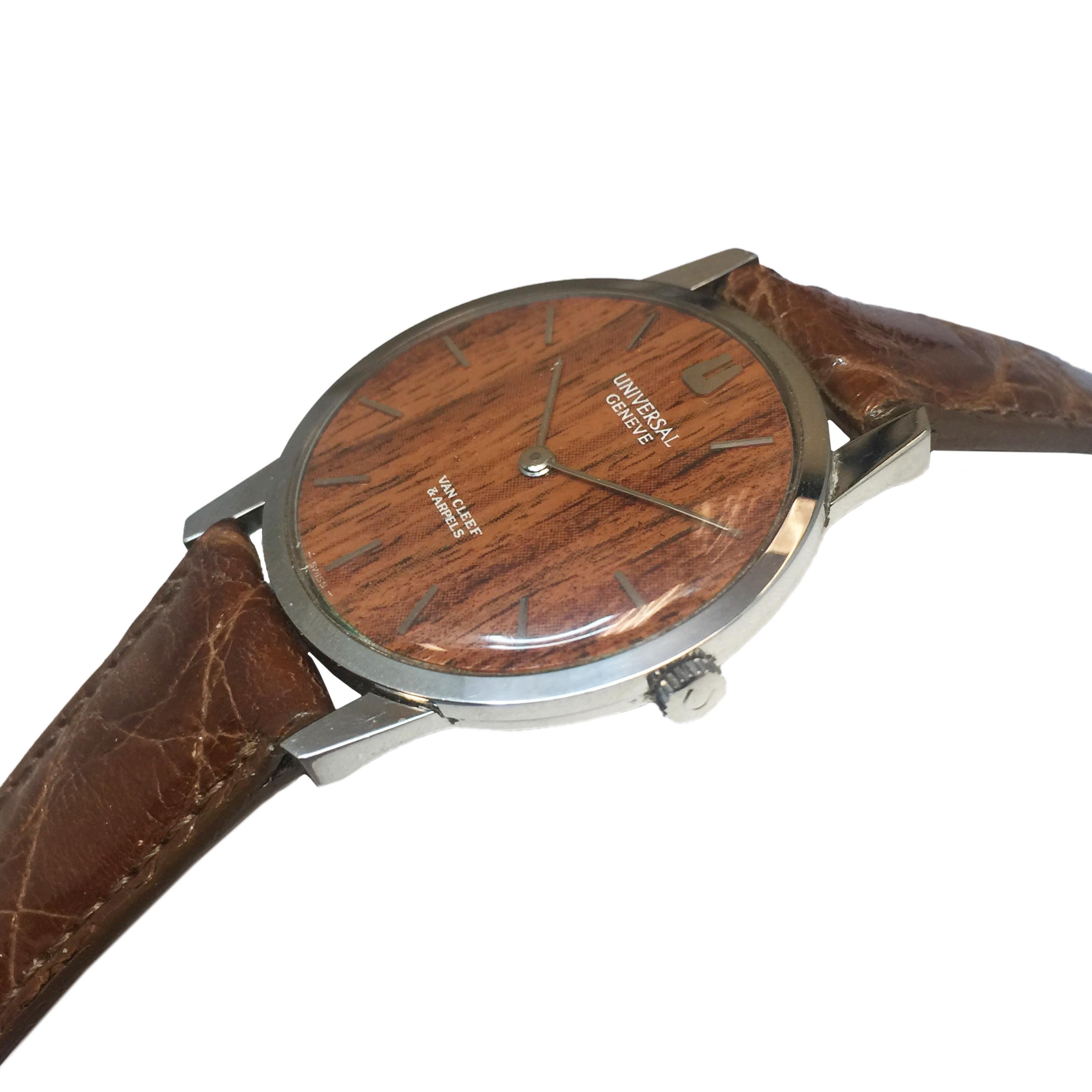Circa 1970s Universal Geneve Retailed by Van Cleef & Arpels Rare Wood Dial Wrist Watch, 31 MM Diameter 3 piece Stainless Steel Case, 6 MM thick. 17 Jewel Mechanical, manual wind movement.   Fitted with a Wood Dial and having raised Markers. Hadley