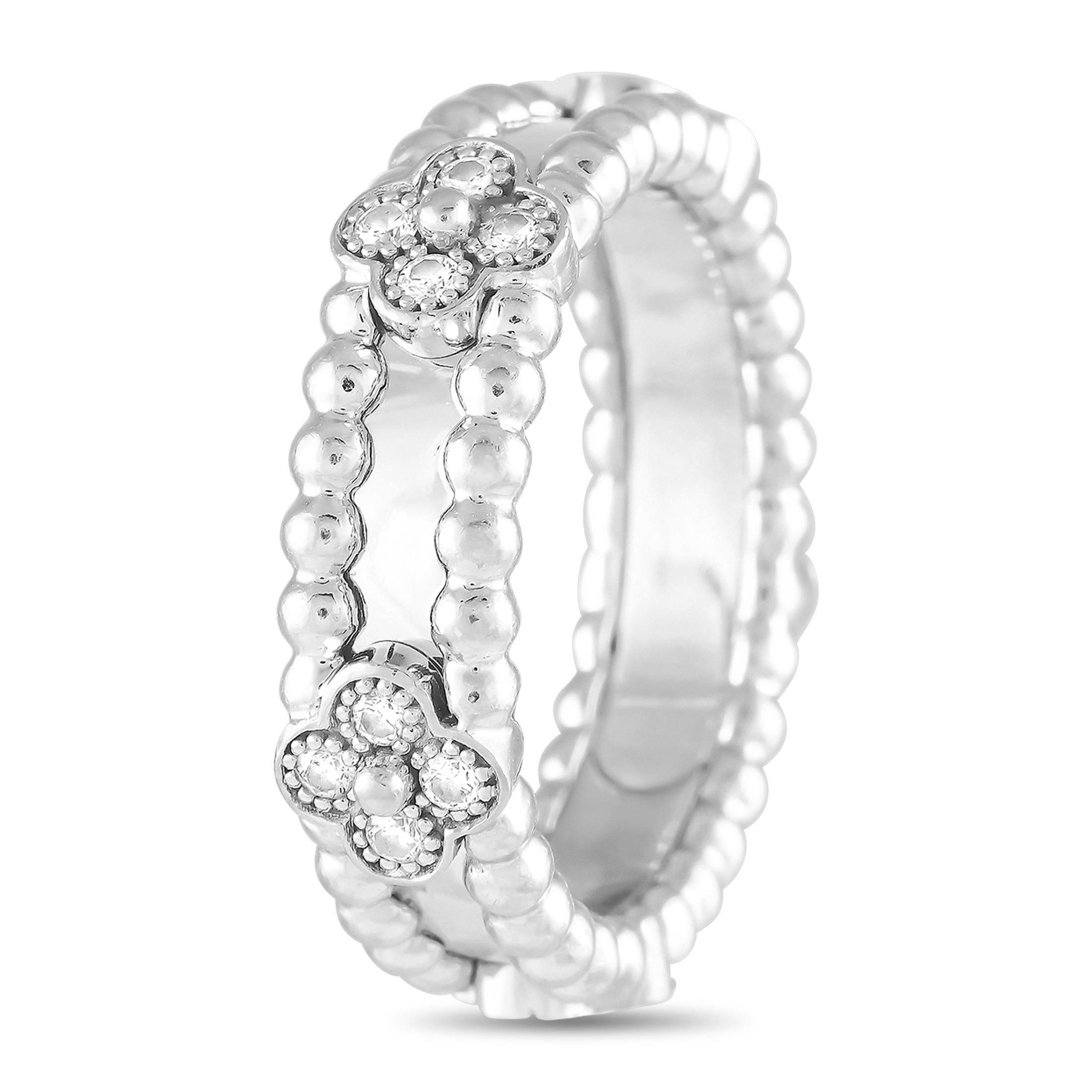 This Van Cleef & Arpels Perlee ring combines 18K White Gold beadwork with the brands iconic clover motifs. Diamond accents totaling 0.33 carats adds extra elegance to this simple, sophisticated accessory. This piece measures 5mm wide and features a