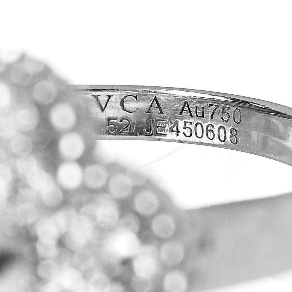 This is an authentic VAN CLEEF 
ARPELS 18K White Gold Diamond Vintage Alhambra Ring size 52 or 6. The ring is crafted of 18 karat white gold and features an Alhambra clover motif pave set with round brilliant cut diamonds, approximately .48