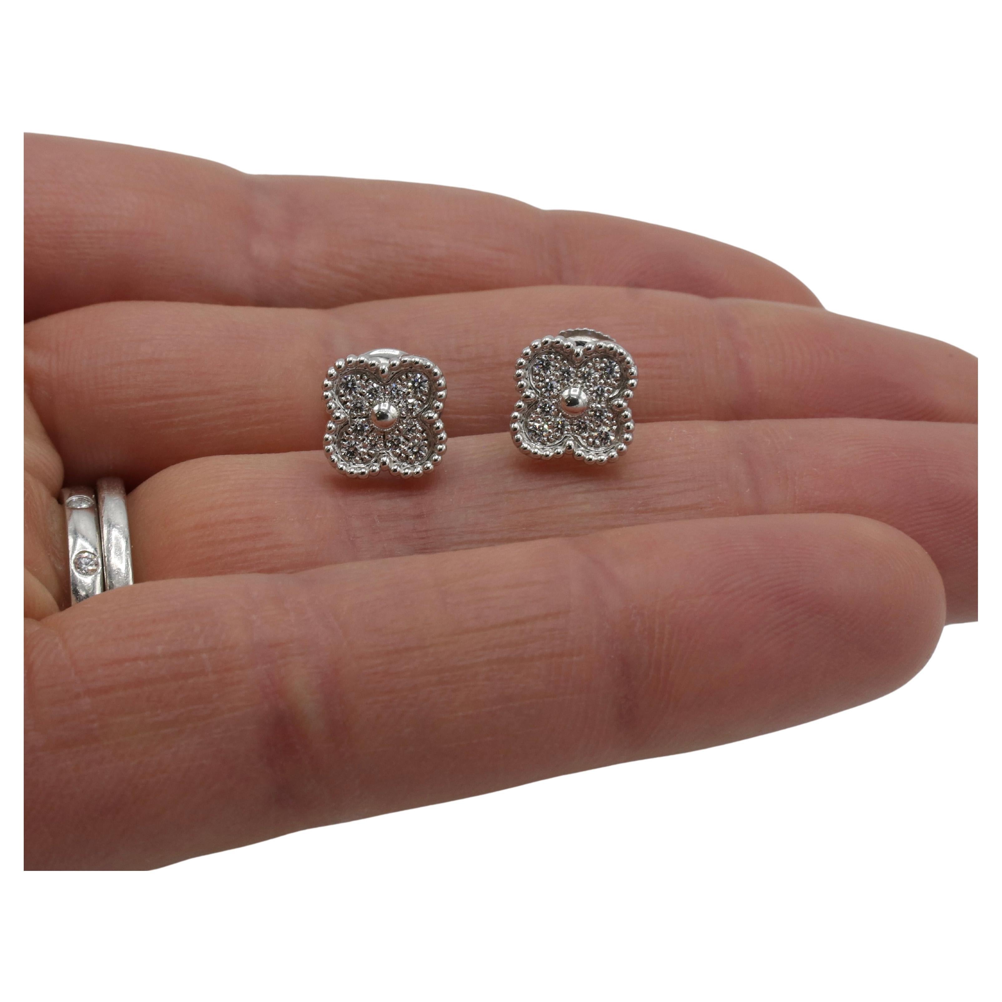 Van Cleef & Arpels VCA Sweet Alhambra White Gold Natural Diamond Stud Earrings 
Metal: 18 karat white gold
Weight: 3.25 grams
Diamonds: Approx. 0.16 carats round natural diamonds DEF, IF-VVS
Dimensions: 9.5 x 9.5mm 
Retail: $6,000 USD
