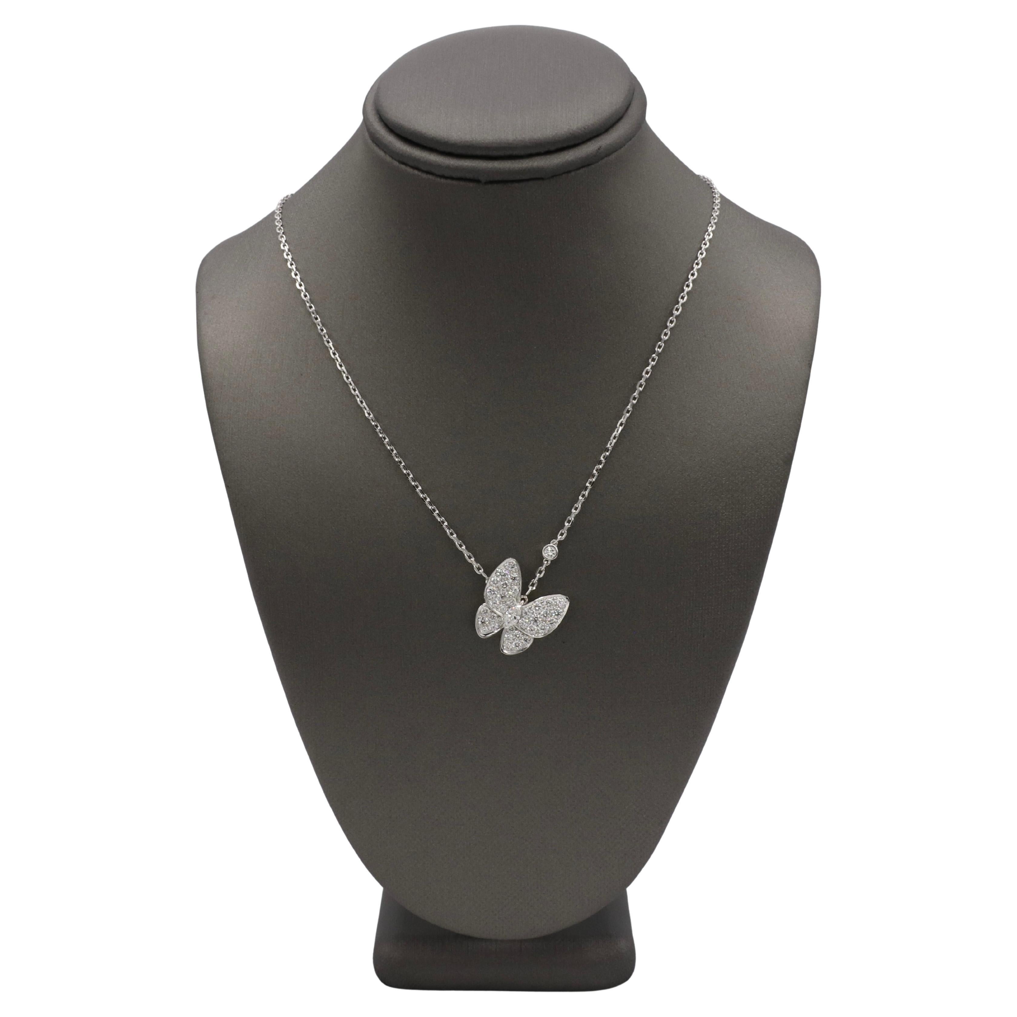 Van Cleef & Arpels VCA Two Butterfly Natural Diamond Pendant Necklace 
Metal: 18k white gold
Weight: 6.12 grams
Diamonds: 0.88 CTW D-F IF-VVS round natural diamonds
Chain: 16.54 inches
Retail: $16,800 USD
Notes: Box and papers 