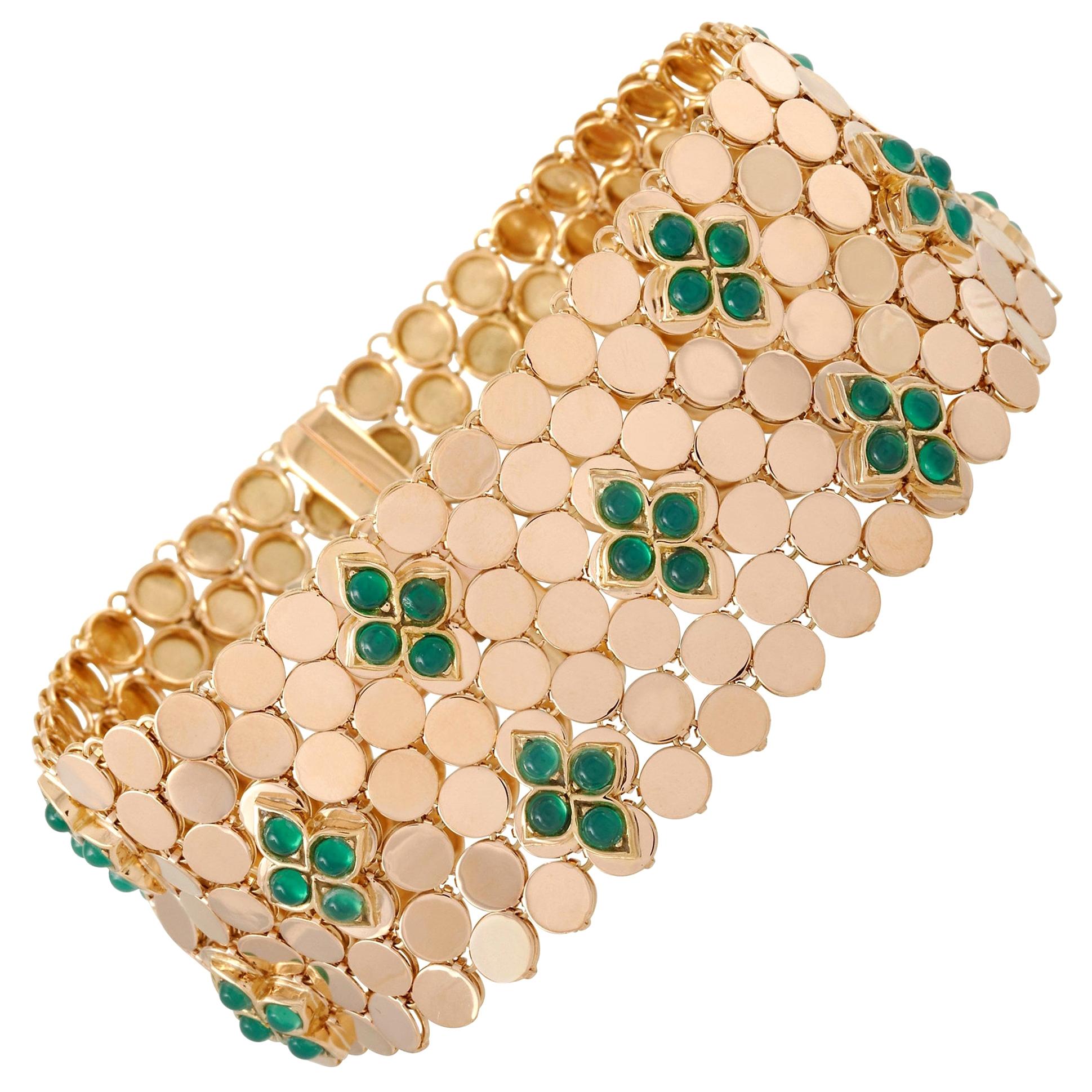 The Van Cleef & Arpels Vintage 18K Yellow Gold Emerald Mesh Bracelet has that ever-desirable poise and elegance of VCA. This wide bracelet features a mosaic of small 18K yellow gold circles making up an openwork structure that delicately caresses