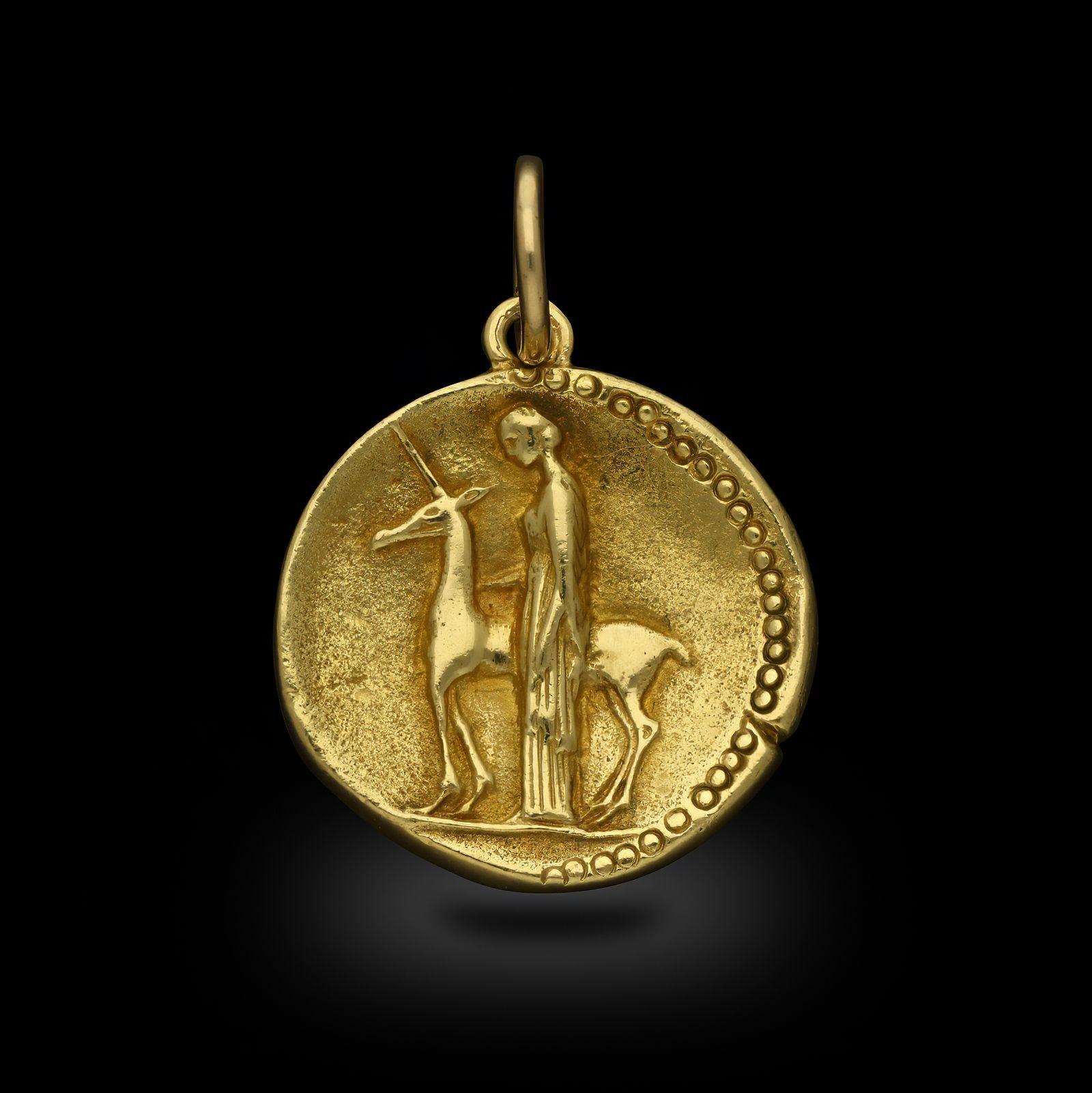 An 18ct gold Virgo Zodiac pendant by Van Cleef & Arpels, circa 1970s. Designed in the style of an ancient coin representing Virgo, on the front is a raised image of a woman standing by a unicorn and on the reverse the dates for Virgo in Roman