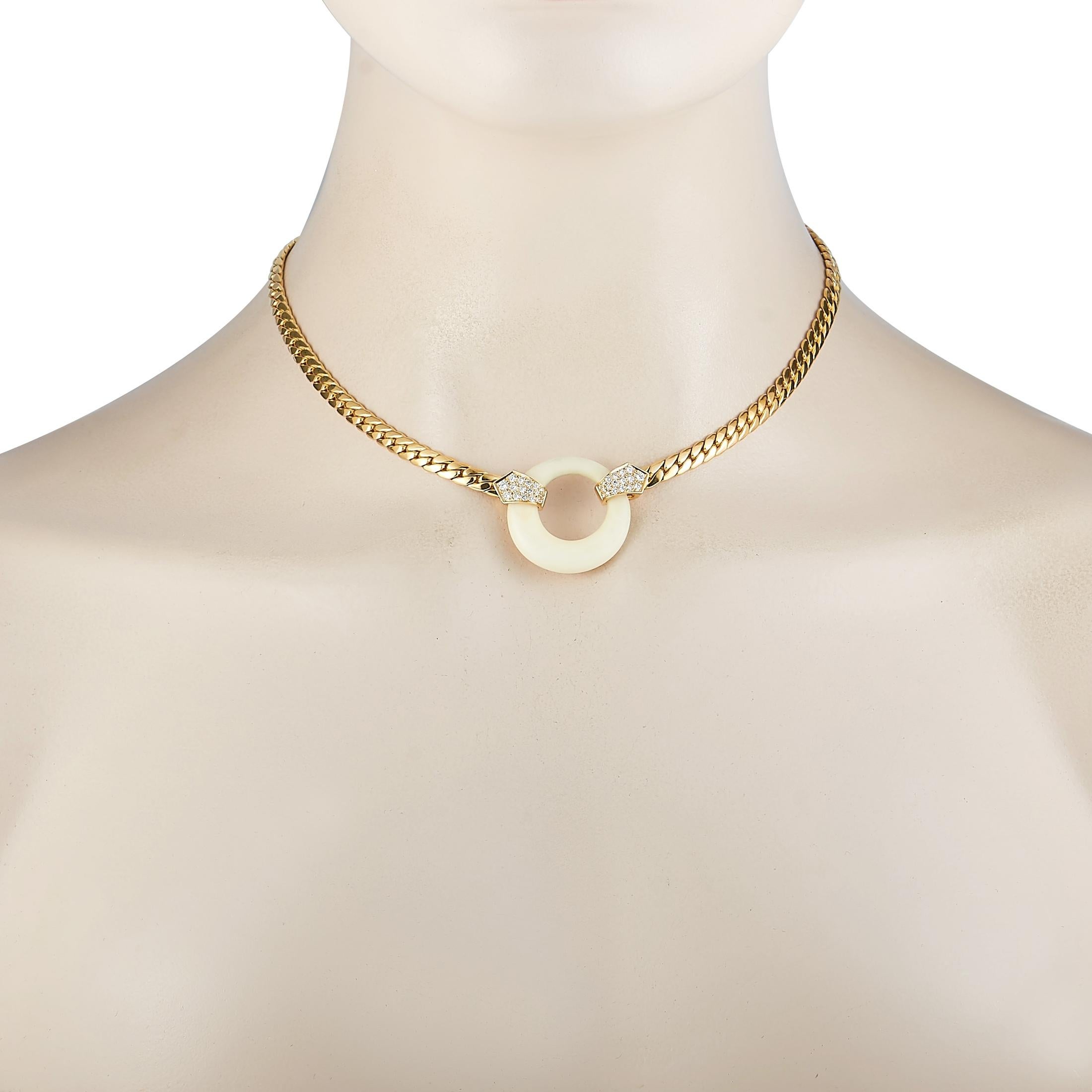 This vintage Van Cleef & Arpels necklace is crafted from 18K yellow gold and weighs 45.7 grams. It is presented with a 14” chain and a white coral pendant that measures 1.14” in length and 1.10” in width. The necklace is embellished with diamonds