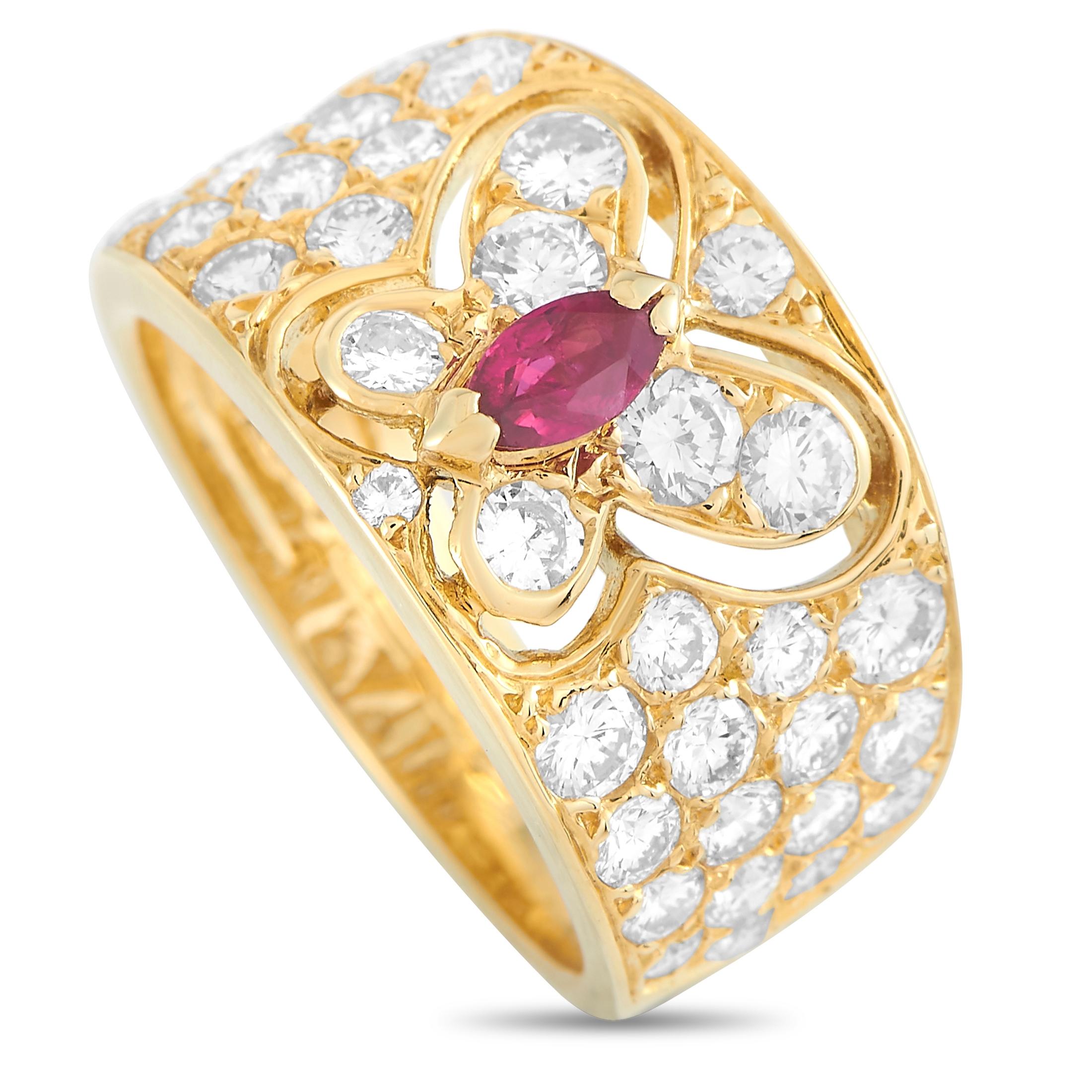 This vintage Van Cleef & Arpels ring with a butterfly motif is crafted from 18K yellow gold and weighs 6.9 grams. It boasts band thickness of 5 mm and top height of 2 mm, while top dimensions measure 11 by 18 mm. The ring is set with a ruby and a