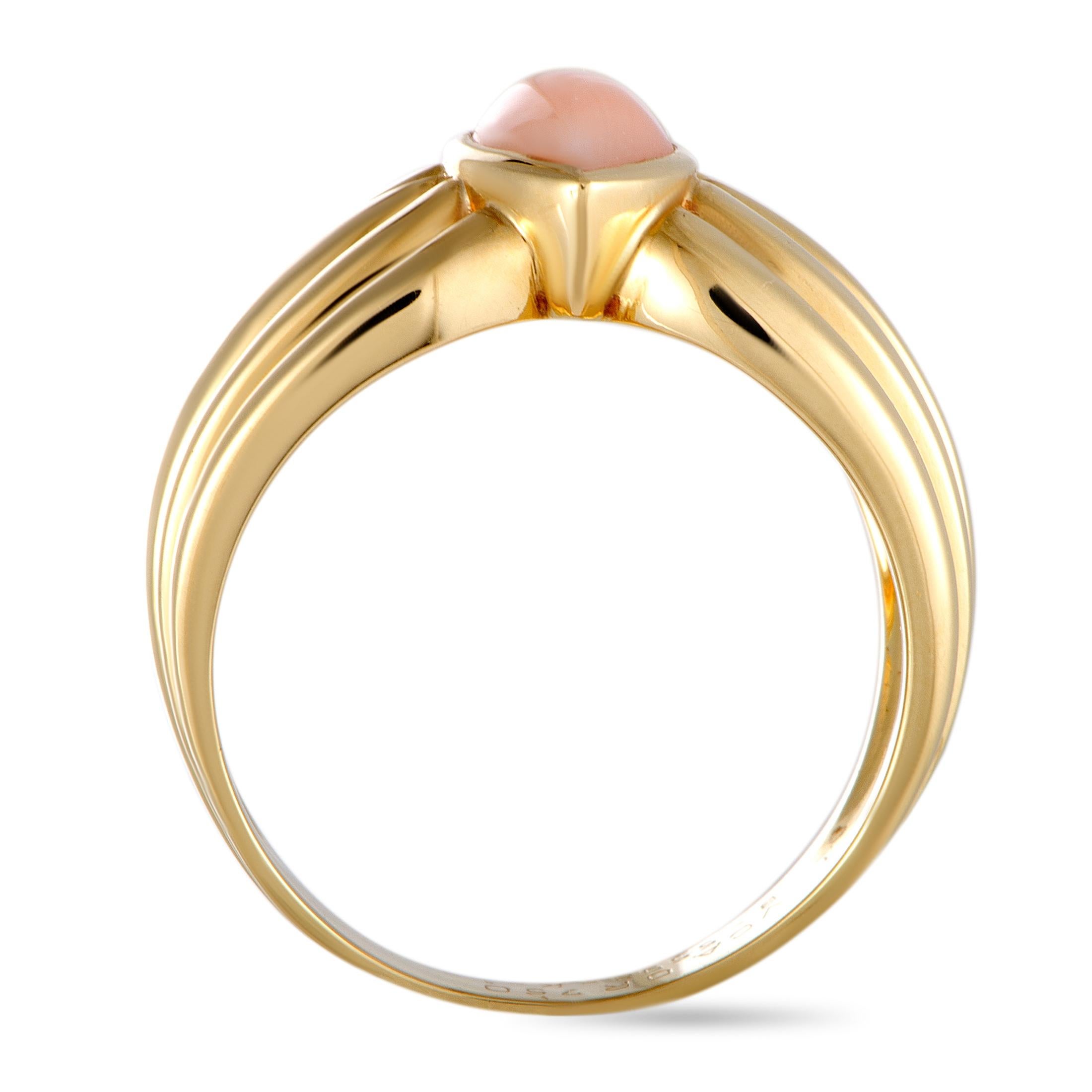 This vintage Van Cleef & Arpels ring is made out of 18K yellow gold and coral and weighs 7.2 grams. It boasts band thickness of 4 mm and top height of 5 mm, while top dimensions measure 11 by 4 mm.

Offered in estate condition, this item includes