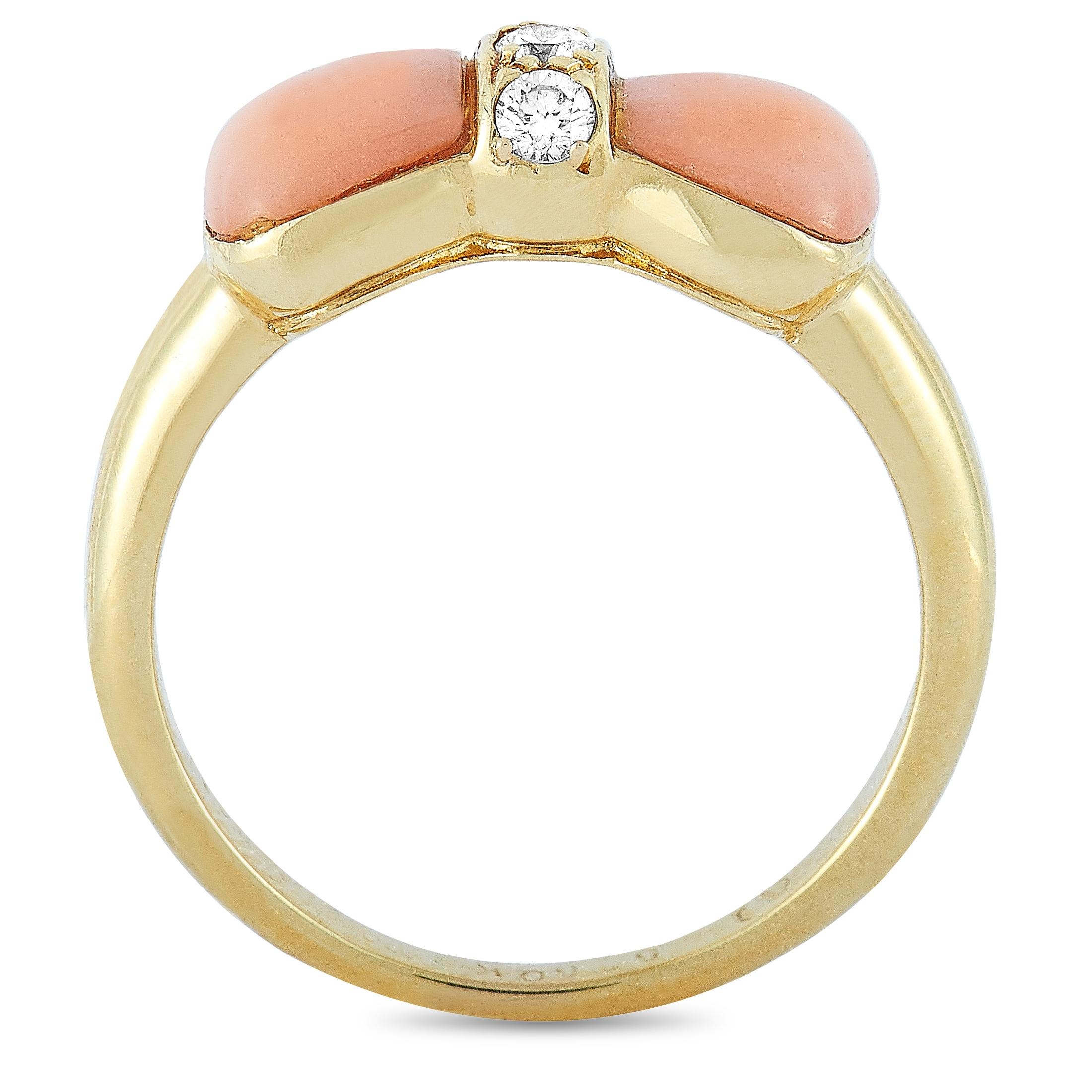 This vintage Van Cleef & Arpels bow ring is crafted from 18K yellow gold and embellished with diamonds and pink coral. The ring weighs 4.1 grams and boasts band thickness of 2 mm and top height of 4 mm, while top dimensions measure 14 by 6 mm.
Ring