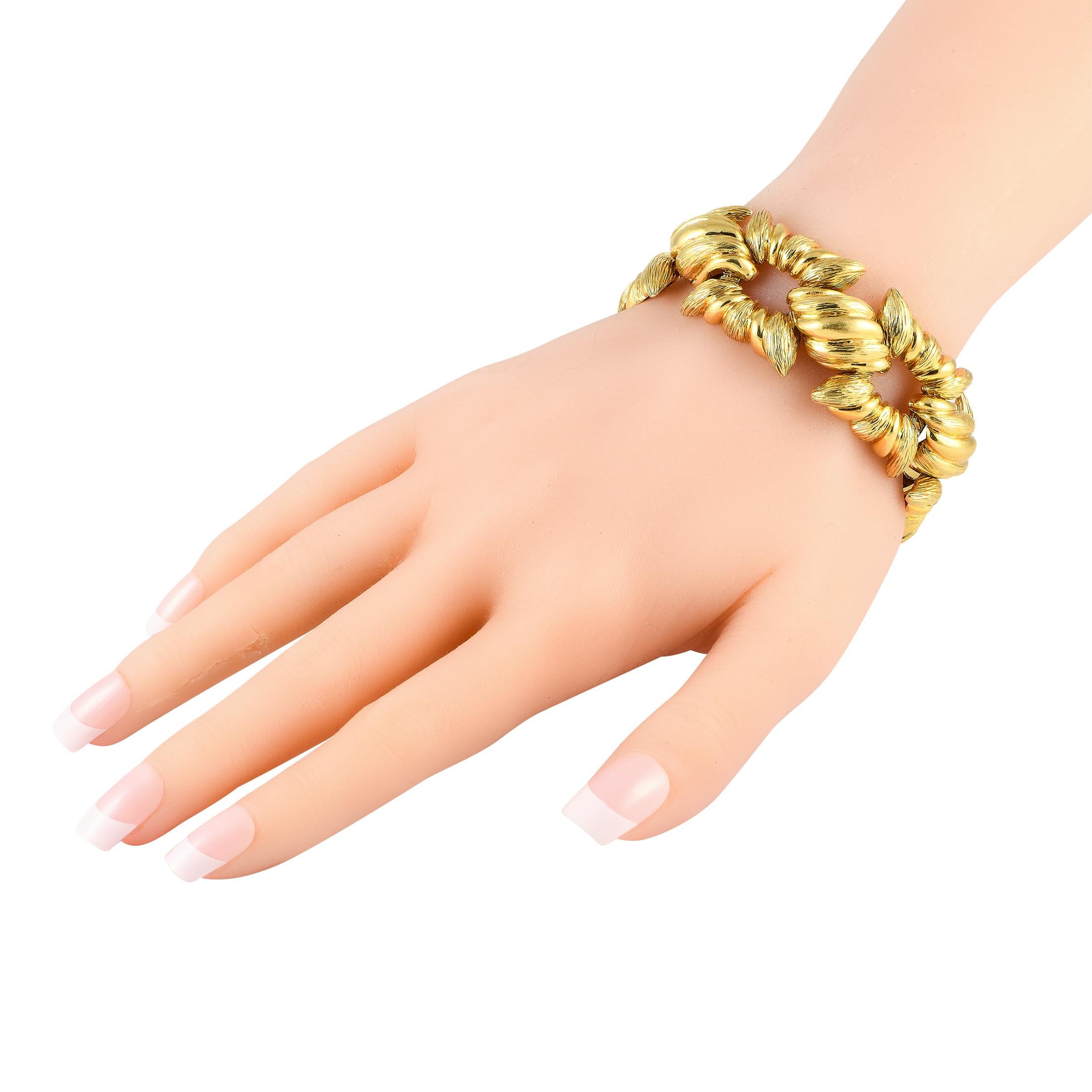 Consider this yellow gold bracelet an easy-to-wear statement piece that can instantly add dimension and texture to your accessorizing style. The bracelet features rigid and fluted square-shaped links connected by twisted shell-like links. The