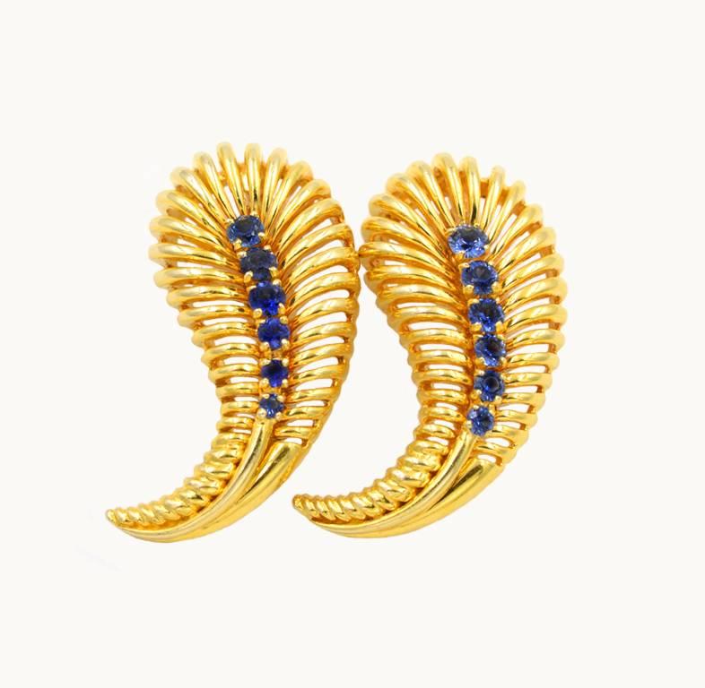 Van Cleef and Arpels vintage 18 karat yellow gold and sapphire paisley brooches from circa the 1960s.  These awesome brooches feature 6 round sapphires that graduate in size.  Van Cleef and Arpels signed and numbered.

These brooches each measure