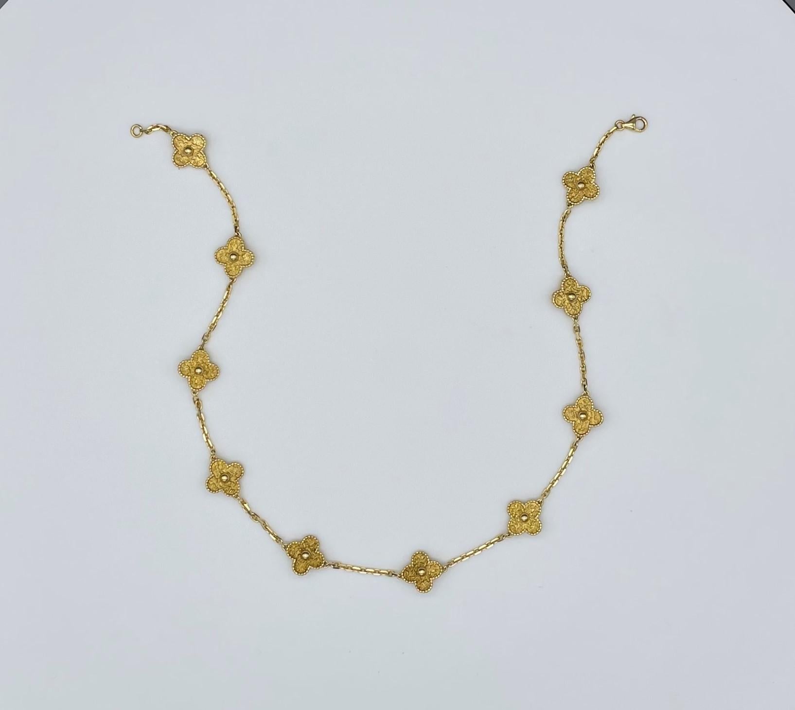 Classic Van Cleef & Arpels Vintage Alhambra necklace featuring 10 motifs in 18 karat yellow gold. Each four-leaf clover motif (symbol of good luck) is adorned with a border of golden beads and its inner area is intricately and uniquely texturized