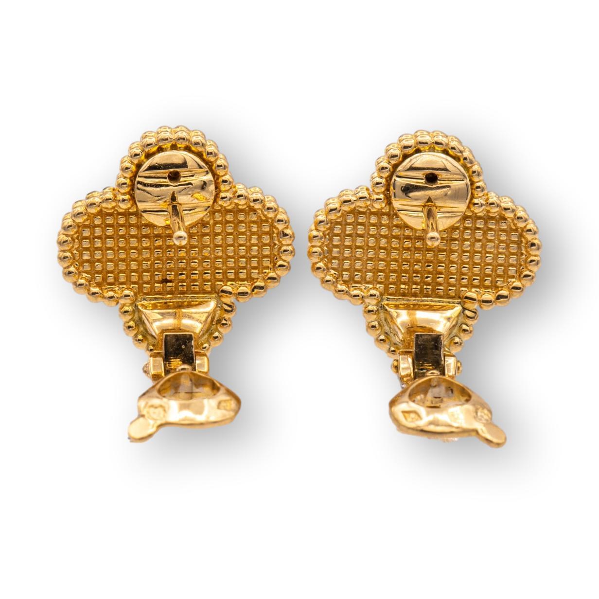 Van Cleef & Arpels clip earrings from the Vintage Alhambra collection finely crafted in 18 Karat Yellow Gold featuring 2 signature clover motifs with a hammered gold finish and large omega clip backs and posts . Each ornament measures 0.59” Wide and