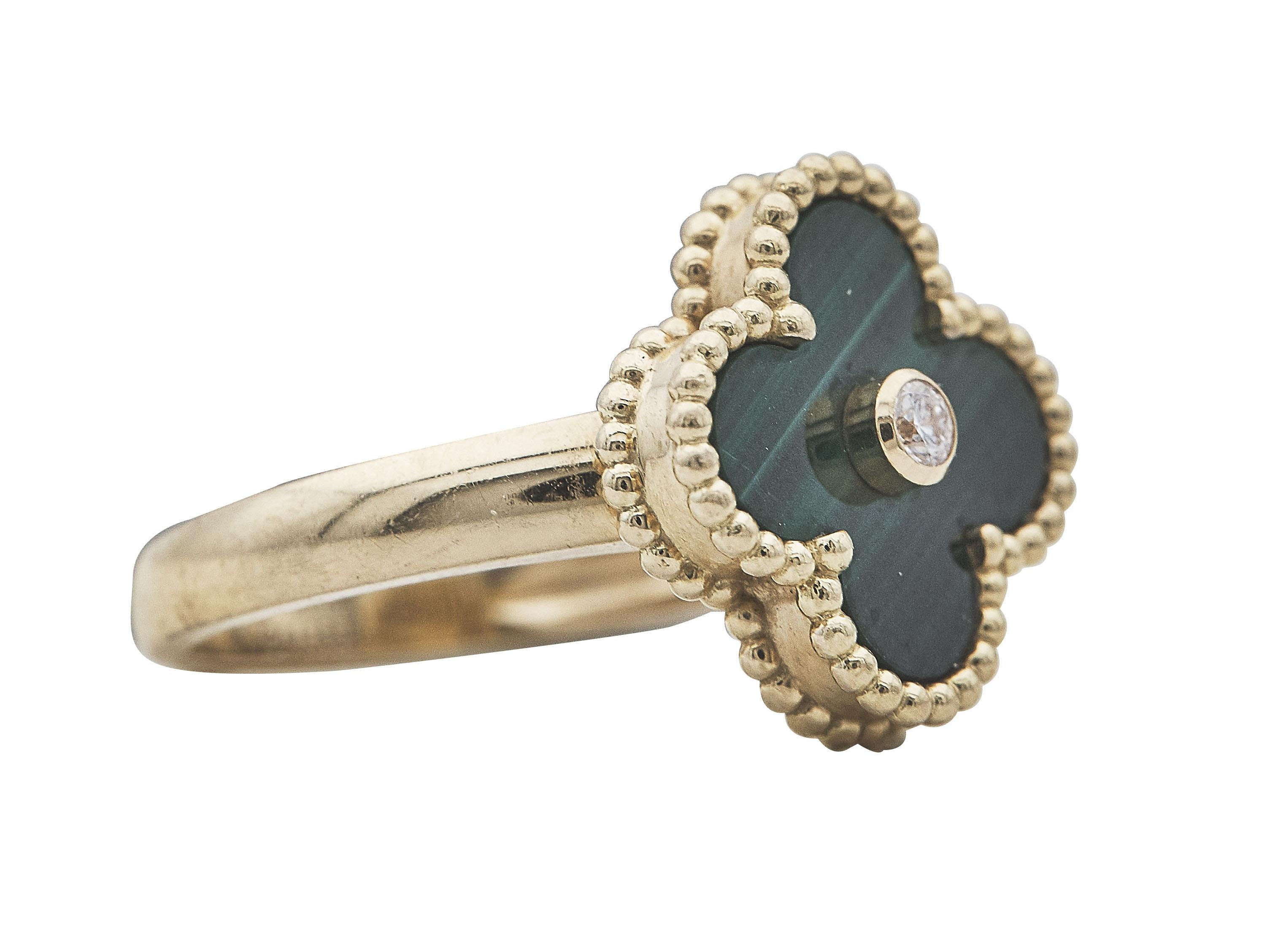 A ring:
A Van Cleef & Arpels Vintage Alhambra eighteen karat yellow gold malachite diamond ring. Designed as a single carved malachite motif, centered by a bezel set round brilliant cut diamond, further enhanced by beaded gold, on a brightly