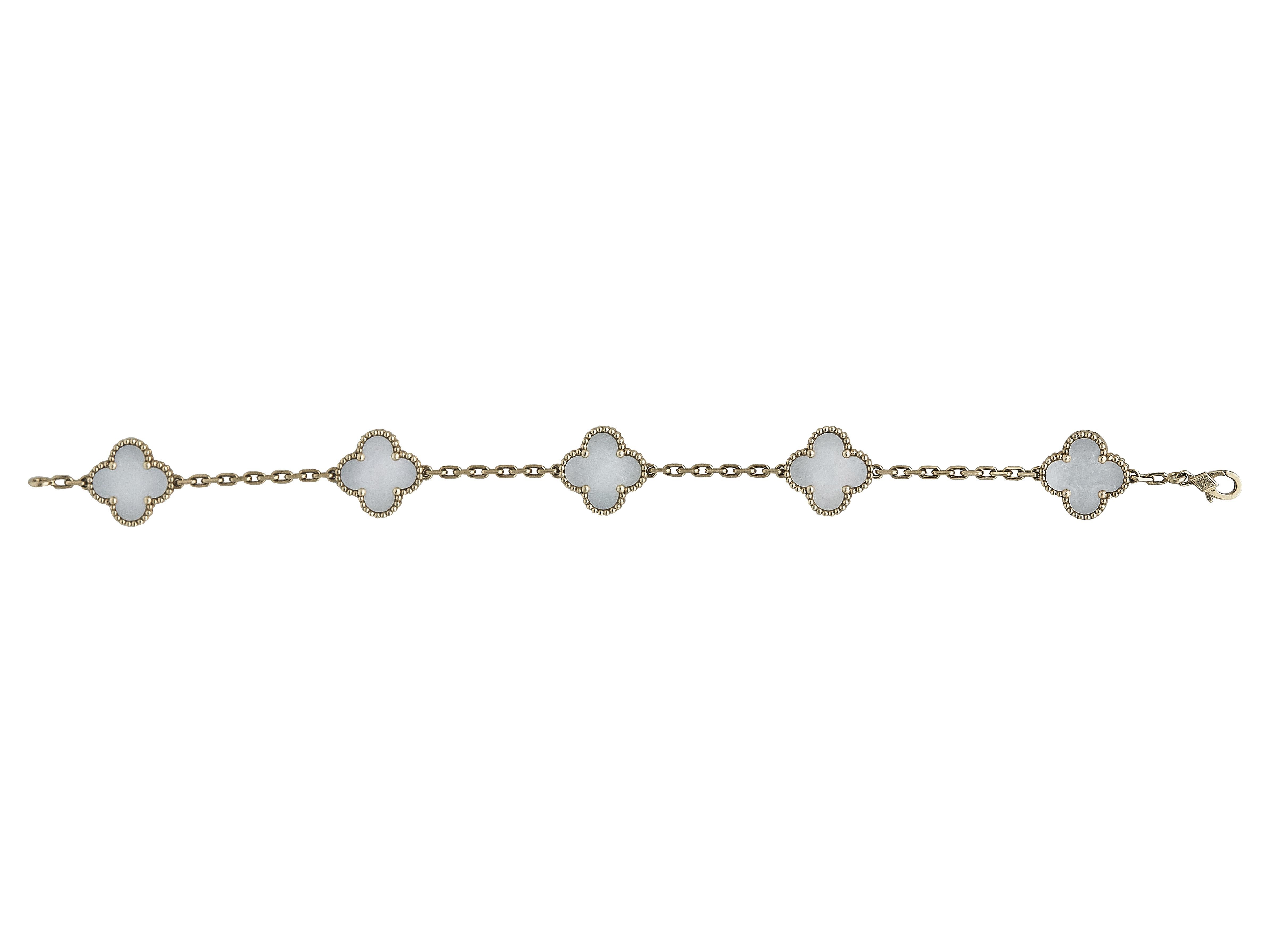 The bracelet: A Van Cleef & Arpels Vintage Alhambra bracelet. Designed as five mother-of-pearl motifs set in eighteen karat yellow gold.

The bracelet is in excellent condition, with only a few minor scratches that are expected with normal wear.

It