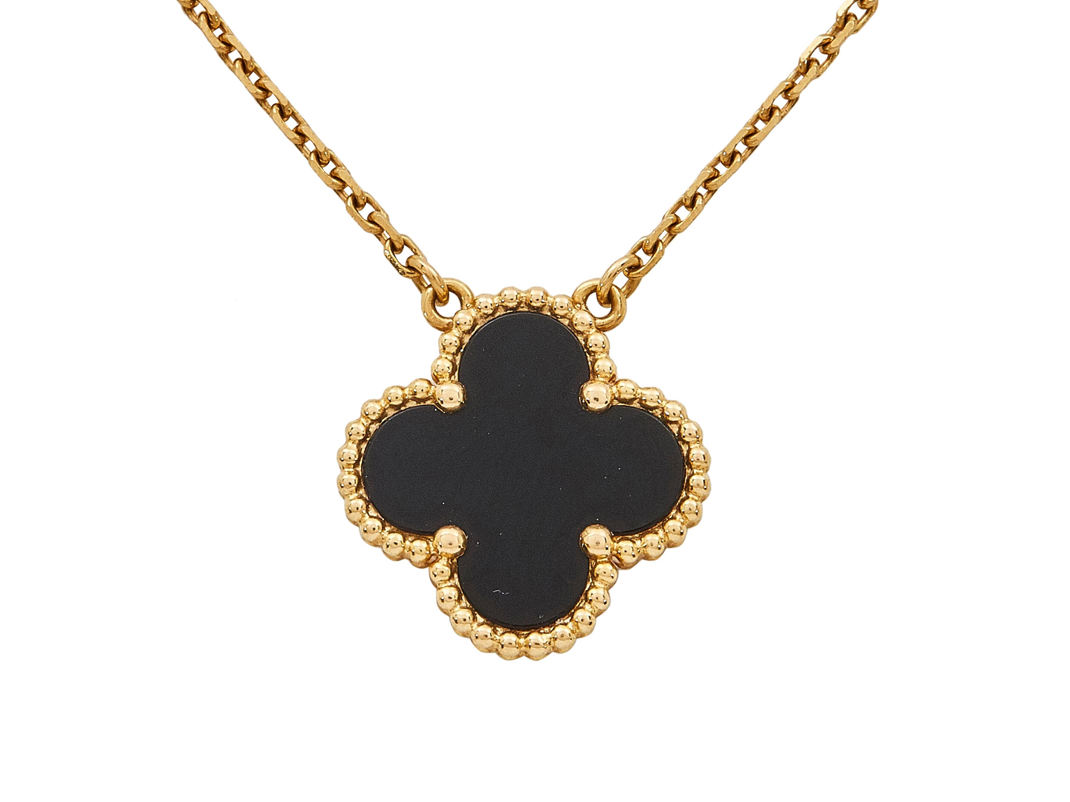 The pendant necklace: 
A Van Cleef & Arpels Vintage Alhambra eighteen karat yellow gold and onyx pendant necklace. A single carved onyx motif is mounted in beaded yellow gold and suspends from a delicate chain necklace.

The pendant necklace is in