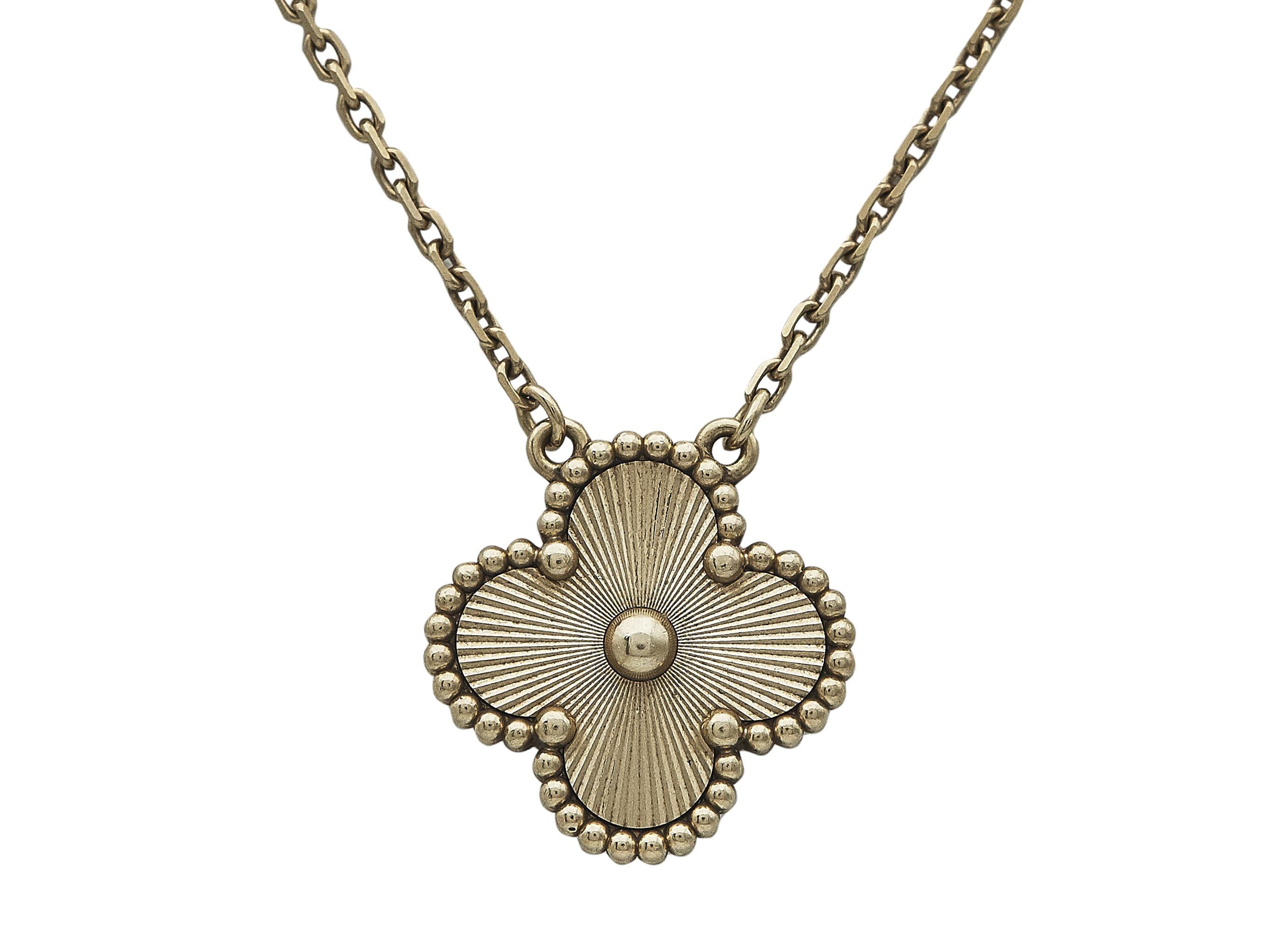 The necklace: A Van Cleef & Arpels Vintage Alhambra eighteen karat yellow gold pendant necklace. The pendant is engraved with scintillating guilloché. It suspends from a delicate chain. This elegant and versatile necklace layers beautifully with