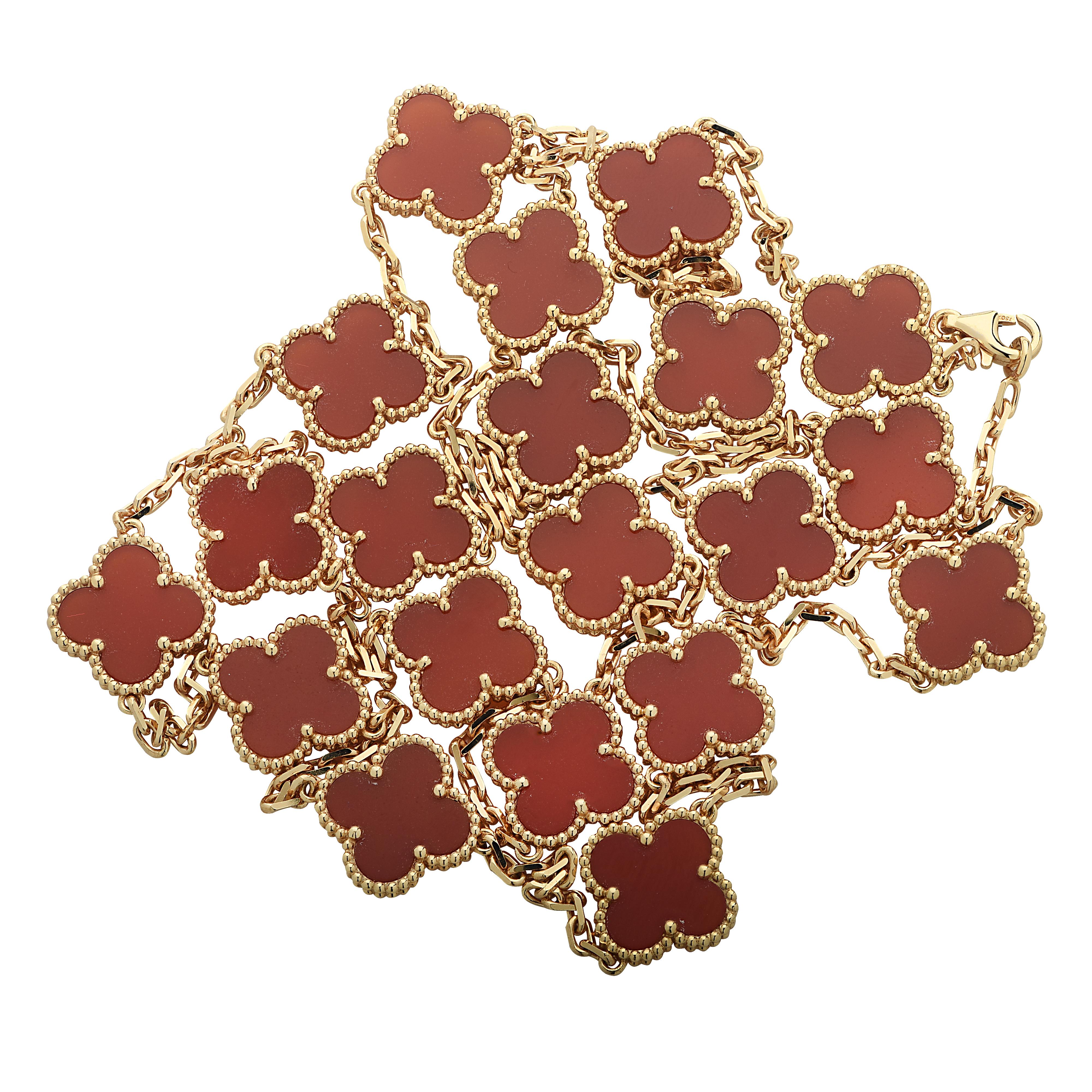 From the House of Van Cleef & Arpels, this exquisite Vintage Alhambra long necklace, 20 motifs, finely handmade in 18 Karat yellow gold, features a symmetrical design inspired by the clover leaf. Twenty clover motifs embellished with Carnelian, are