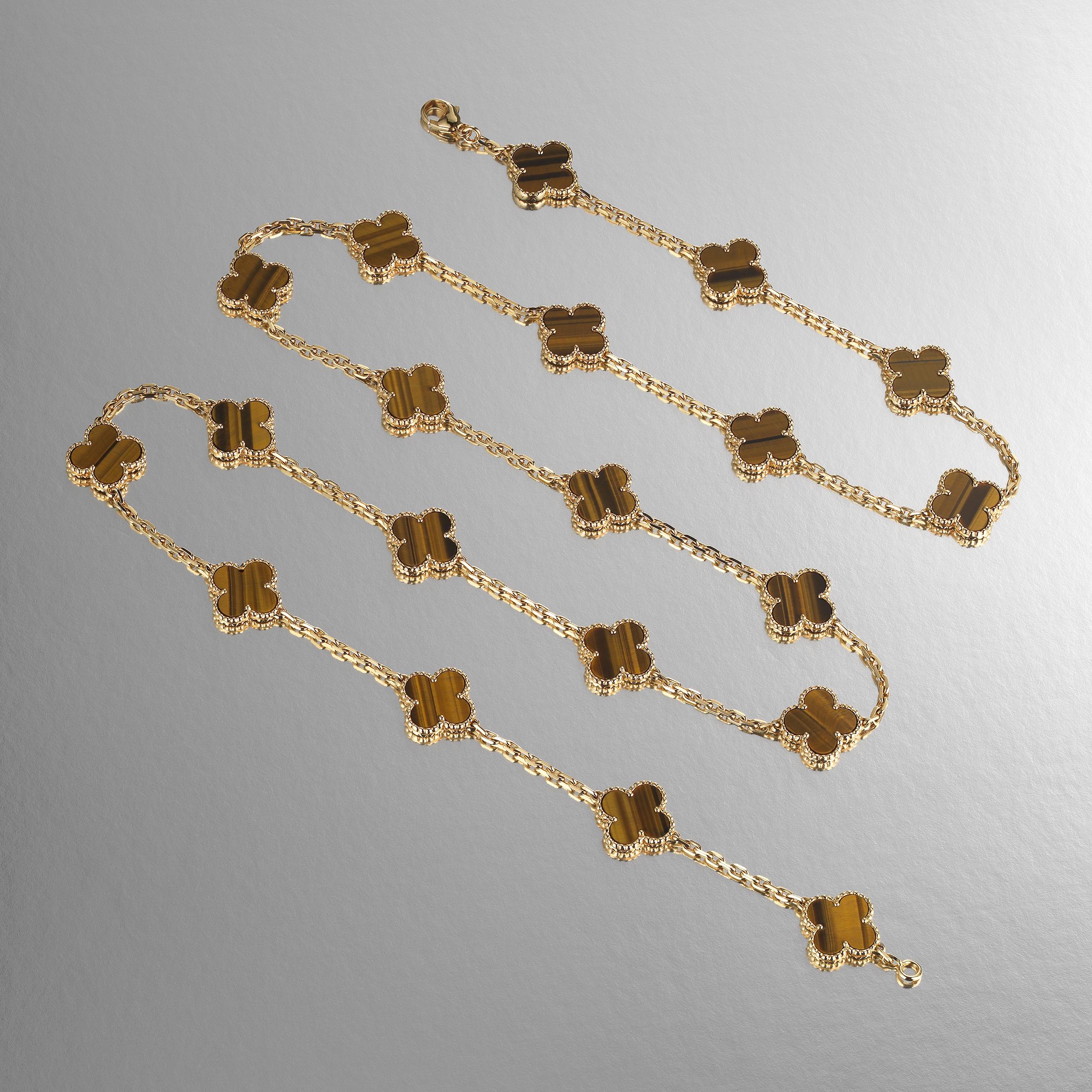 Classic Van Cleef & Arpels Vintage Alhambra long-version necklace featuring 20 Tiger’s Eye clover motifs and set in 18 karat yellow gold. Created in 1968 and taking design cues from traditional Moorish architecture, the Vintage Alhambra creations by