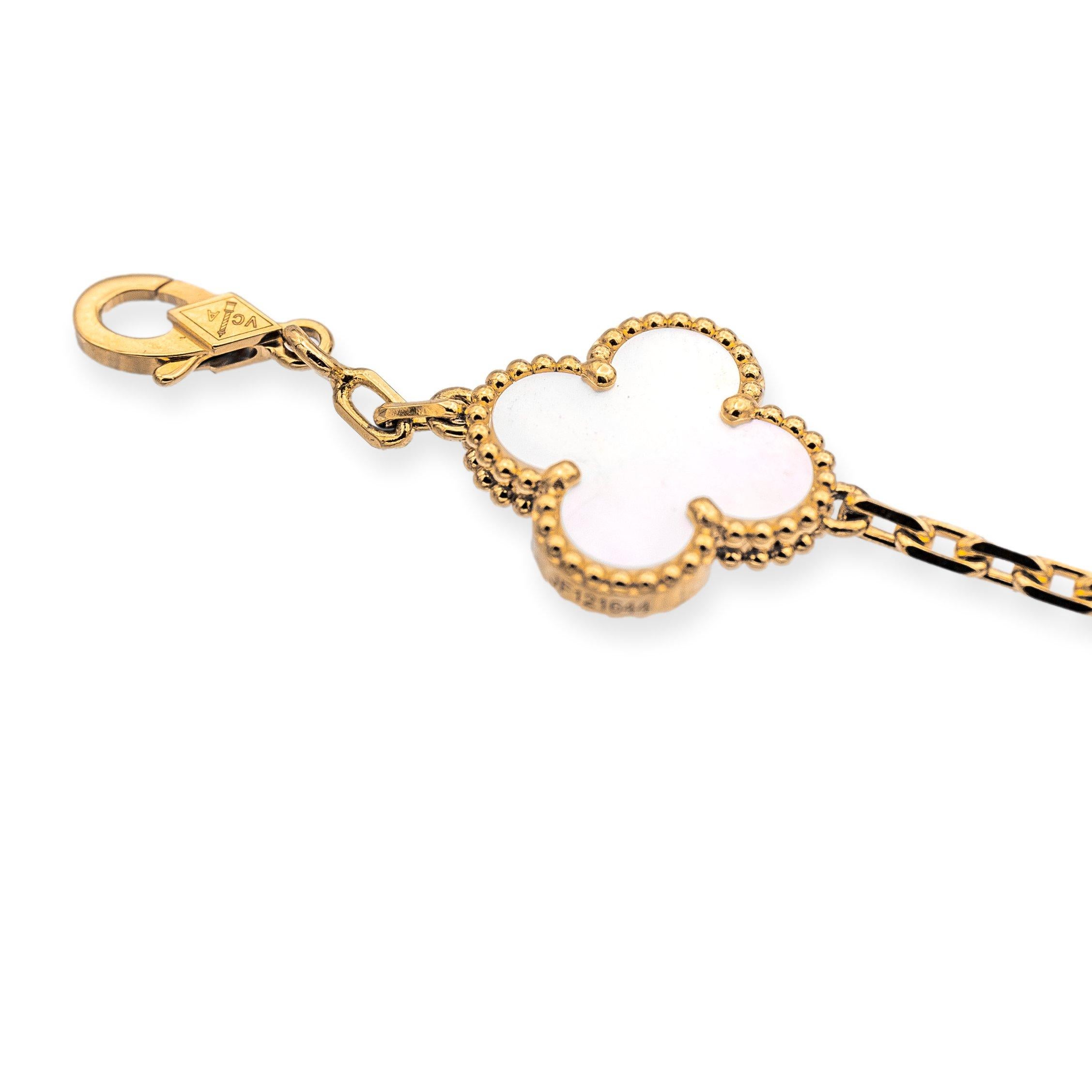 Van Cleef & Arpels bracelet from the Vintage Alhambra collection finely crafted from 18 karat yellow gold. The bracelet measures 7.5 inches long and features five delicate mother of pearl motifs, each set within a gold clover shape, which is the