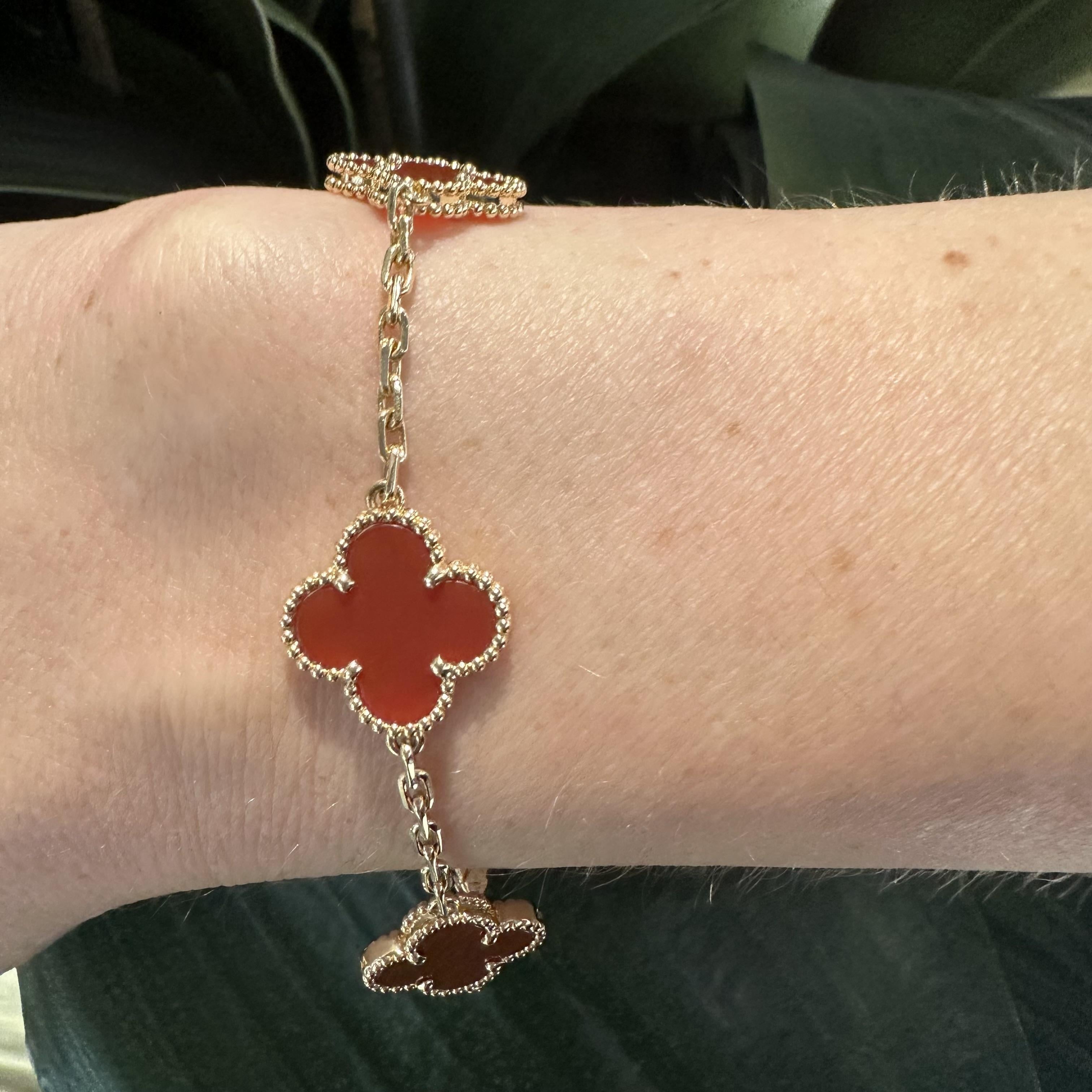 Designer: Van Cleef & Arpels
Collection: Vintage Alhambra
Style: 5 Motifs Bracelet
Material: Yellow Gold
Stones: Carnelian
Metal Purity: 18k
Hallmark: VCA 750 ​​​​​​​Serial No.
Includes:  2 year warranty with Brilliance Jewels, VCA Box, and VCA Copy