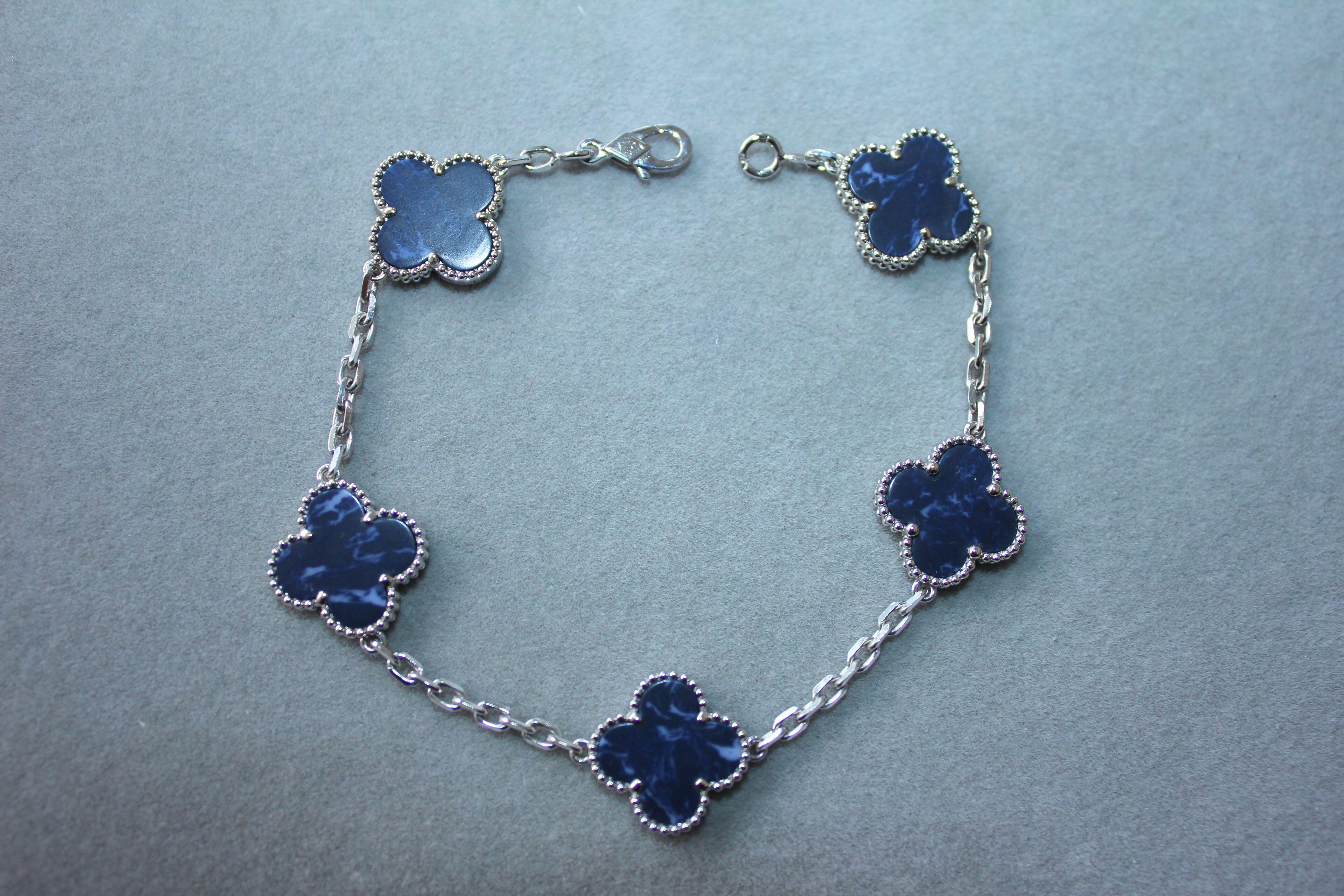 Van Cleef & Arpels Vintage Alhambra Blue Pietersite 18 Karat White Gold Bracelet
18K White Gold AU 750 
Dark Blue Pietersite Motifs with White Cloud Streaks and Details. Very gorgeous Pietersite with beautiful hues, colors, polish and shine. Please