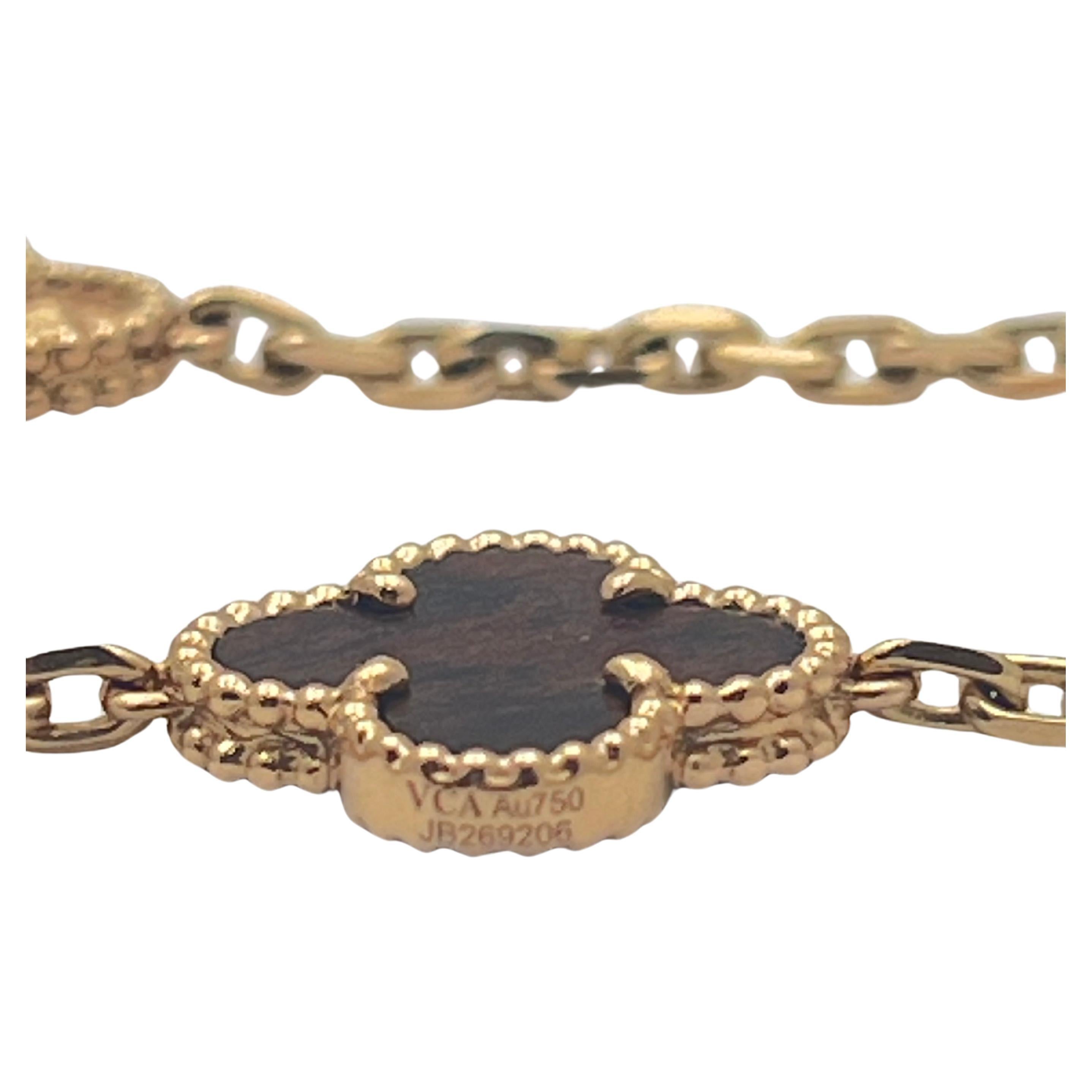 Van Cleef & Arpels Vintage Alhambra limited edition “Bois D’Amourette” necklace, designed with five textured 18k rose gold clover-shaped motifs alternating with five clover-shaped letterwood motifs in 18k rose gold beaded frames, the stations all on
