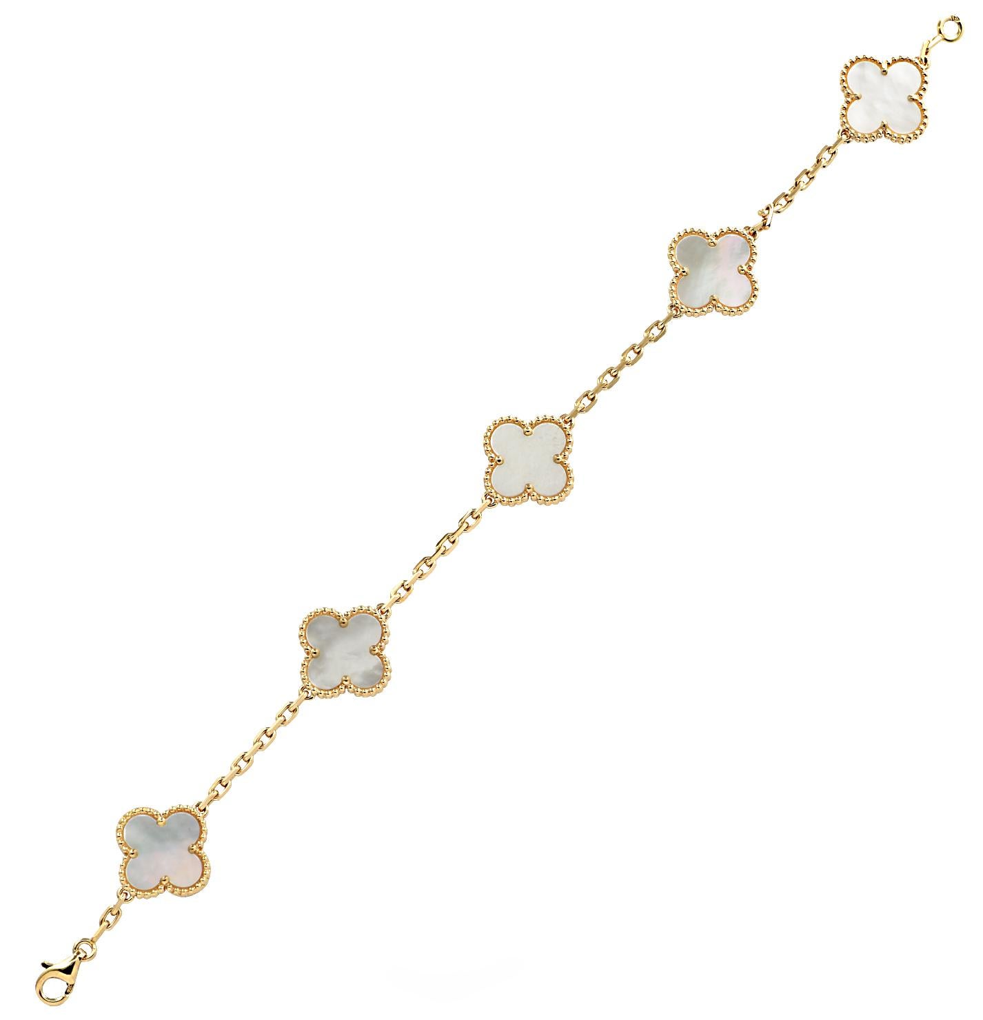 From the House of Van Cleef & Arpels, this exquisite Vintage Alhambra bracelet, 5 motifs, finely handmade in 18 Karat yellow Gold, featuring a symmetrical design inspired by the clover leaf. The clovers are embellished in mother of pearl and are