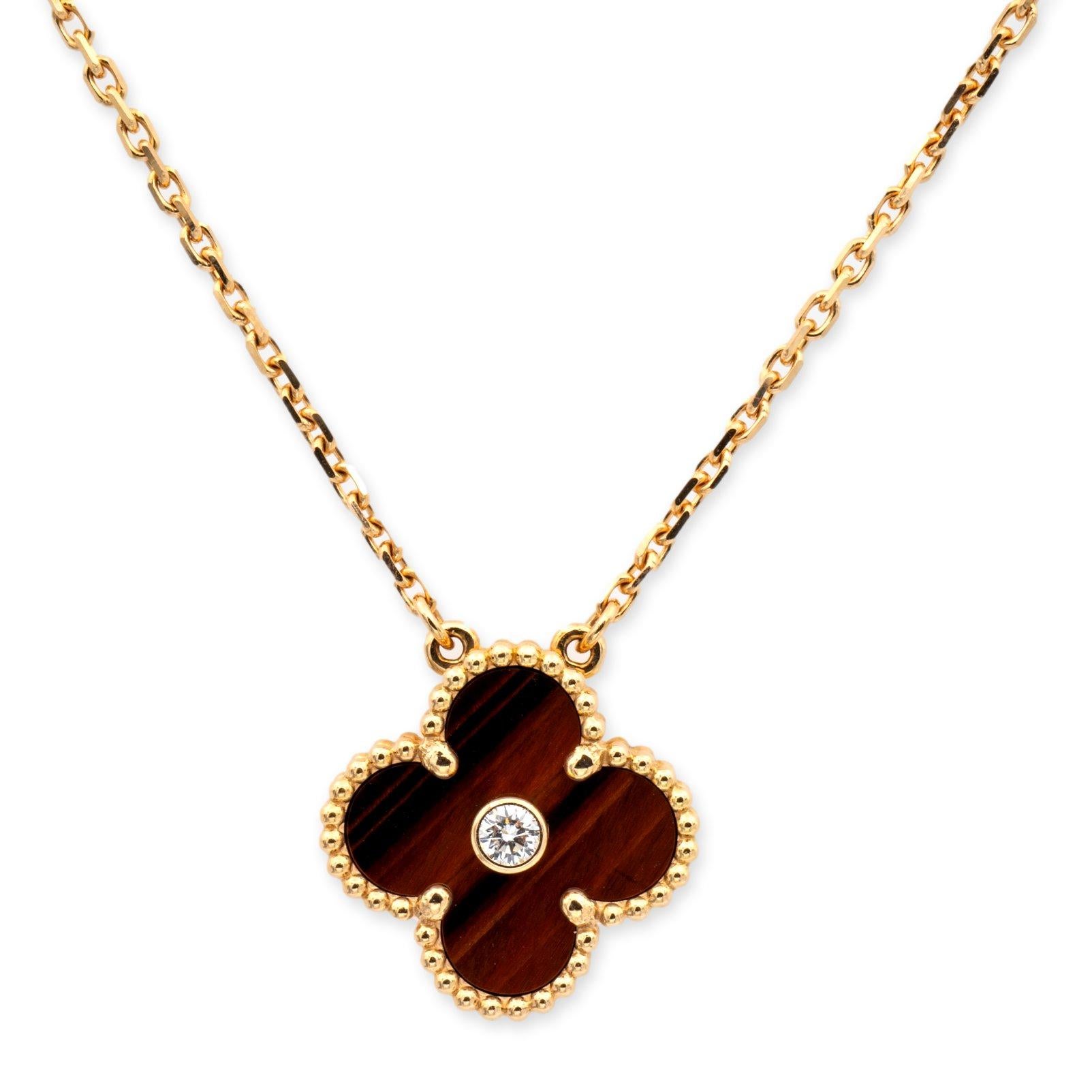 Van Cleef & Arpels necklace from the Vintage Alhambra collection finely crafted in 18 karat rose gold featuring a 15 mm four leaf Bulls-Eye clover motif with a center round  brilliant cut diamond weighing 0.05 cts. The pendant hanging off a 16 inch