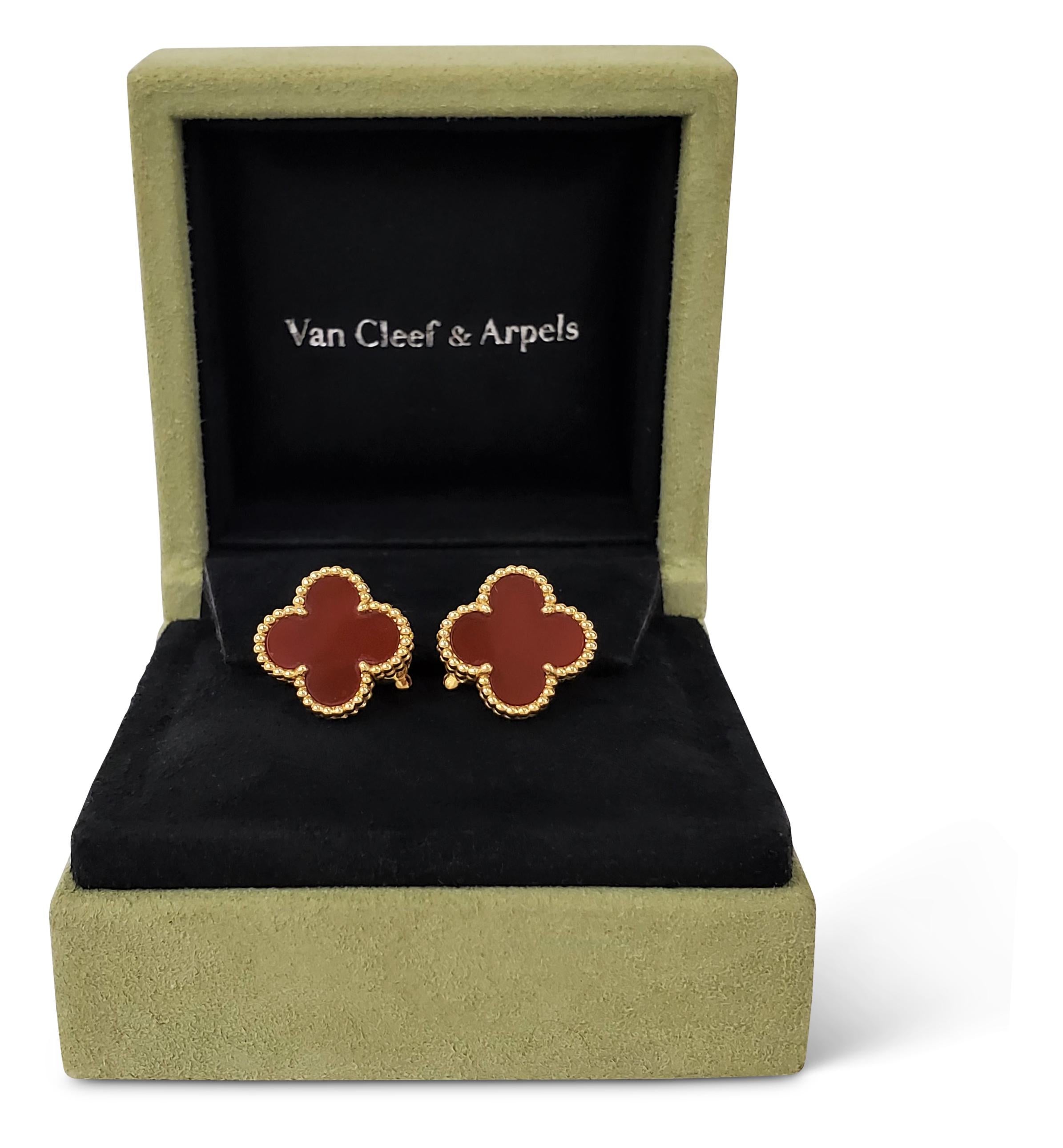 Authentic Van Cleef & Arpels Vintage Alhambra earrings inspired by the clover and crafted in 18 karat yellow gold set with carved carnelian stones. Signed VCA, Au750, with serial number. The earrings measure 15mm in diameter. Presented with original