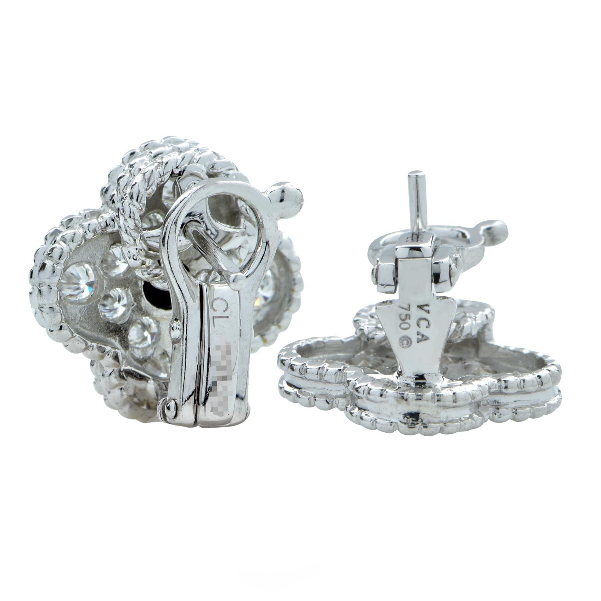 Iconic Van Cleef Arpels vintage Alhambra earrings studded with 24 round brilliant cut diamonds weighing approximately .96 carats total, F color, VVS clarity. These earrings have a clip system with a detachable post.

Our pieces are all accompanied