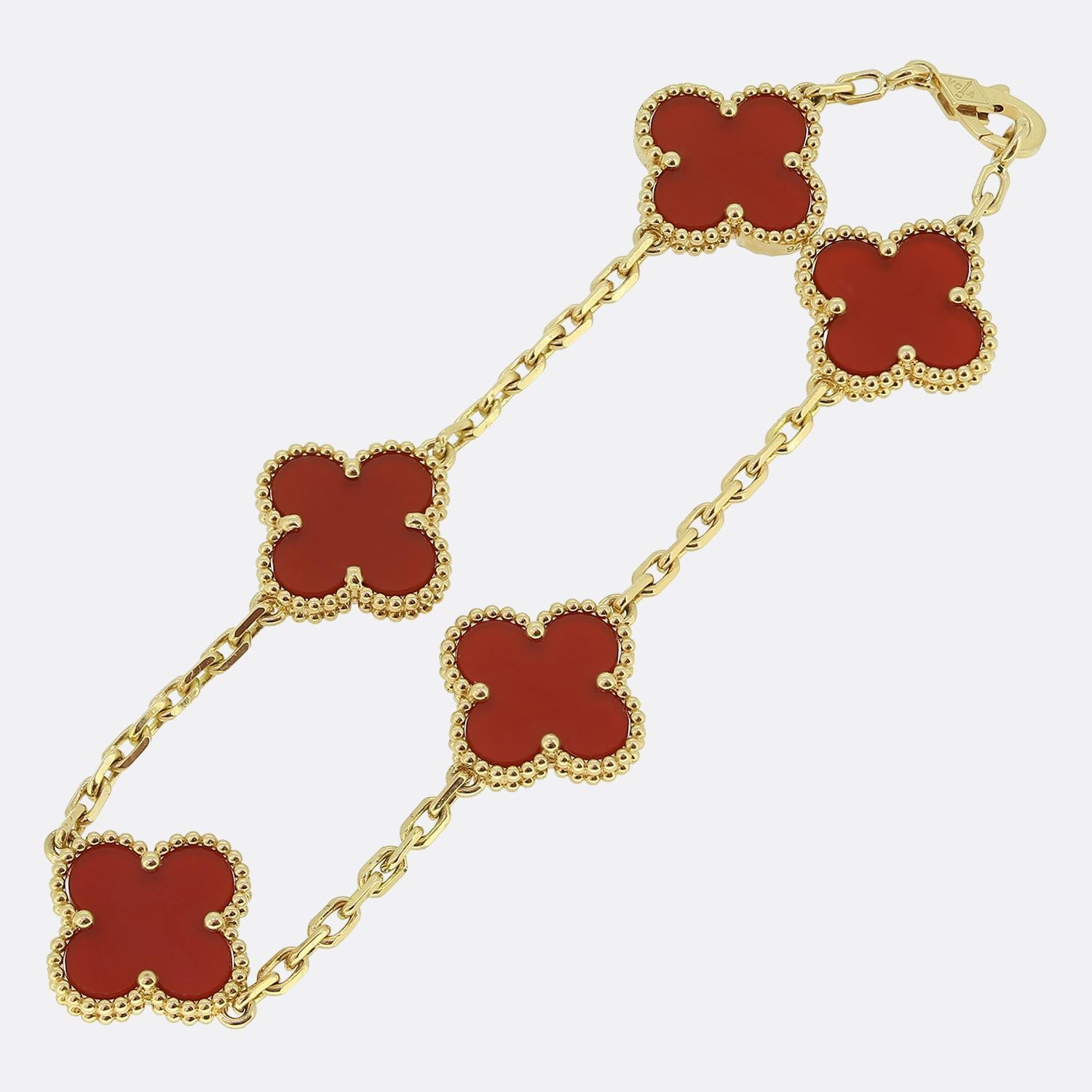 Here we have an iconic bracelet from the world renowned luxury jewellery house of Van Cleef & Arpels. This bracelet forms part of the Vintage Alhambra collection and showcases five yellow gold clover motifs with a beaded edging set with a carnelian
