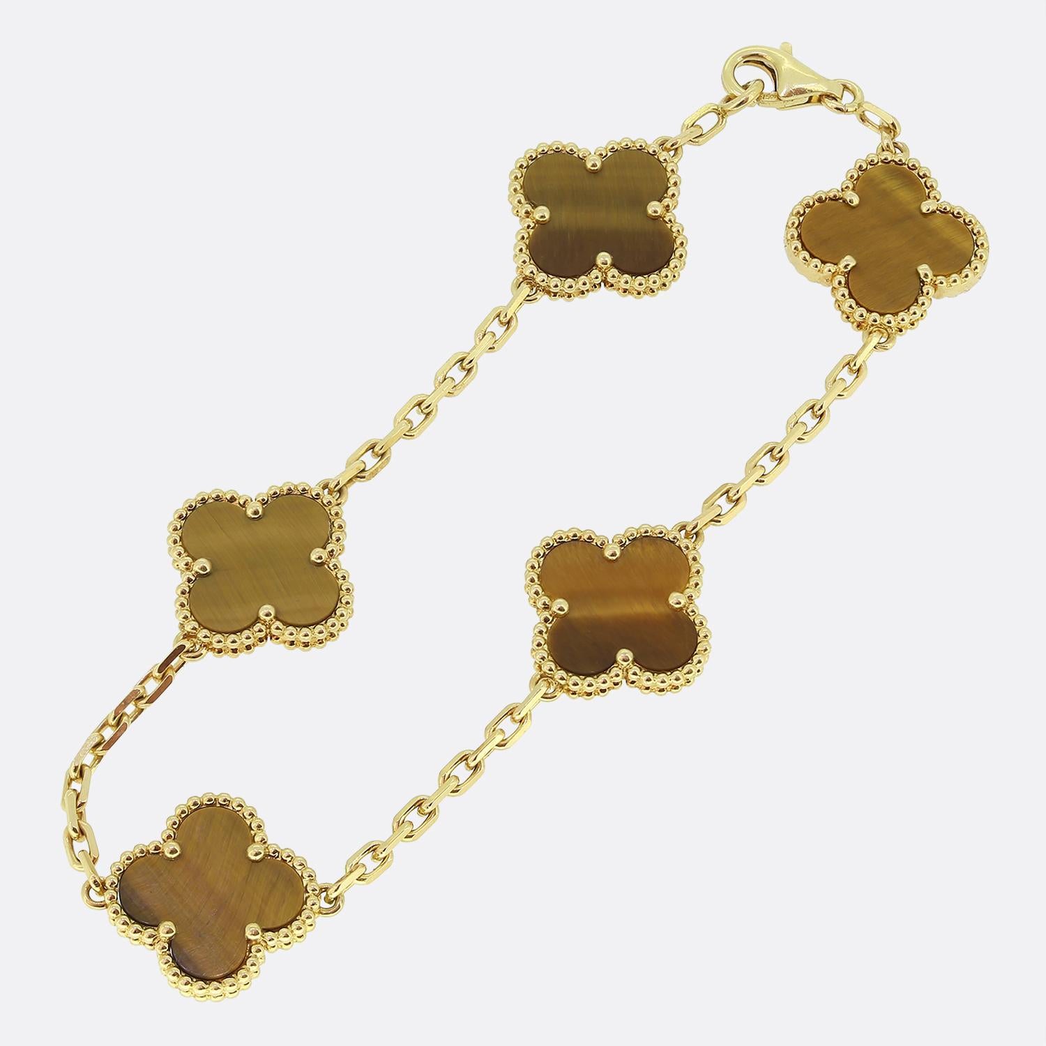 Here we have an iconic bracelet from the world renowned luxury jewellery house of Van Cleef & Arpels. This bracelet forms part of the Vintage Alhambra collection and showcases five yellow gold clover motifs with a beaded edging set with a tigers eye