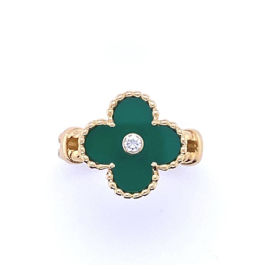 A Van Cleef & Arpels Vintage Alhambra 18 karat yellow gold diamond green chalcedony ring.

Featuring a single iconic clover motif that has become synonomous with Van Cleef and Arpels, a polished sheet of green chalcedony sits within a border of gold