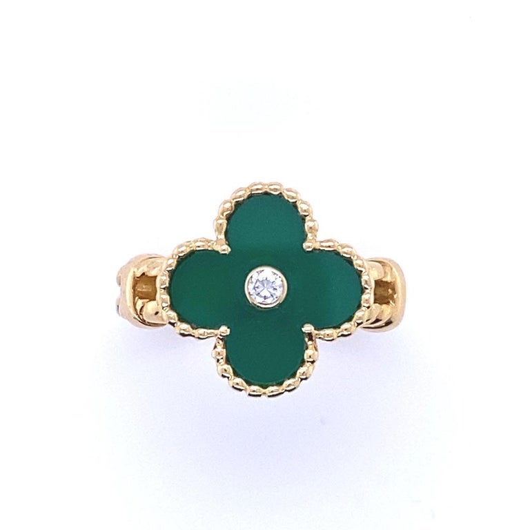 A Van Cleef & Arpels Vintage Alhambra 18 karat yellow gold diamond green chalcedony ring.

Featuring a single iconic clover motif that has become synonomous with Van Cleef and Arpels, a polished sheet of green chalcedony sits within a border of gold