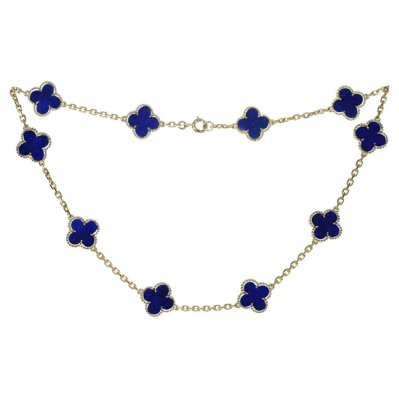 This classic vintage Van Cleef & Arpels necklace is crafted in 18k yellow gold and features 10 lucky clover motifs inlaid with lapis lazuli in round bead settings. Made in France circa 2000. Measurements: 0.59