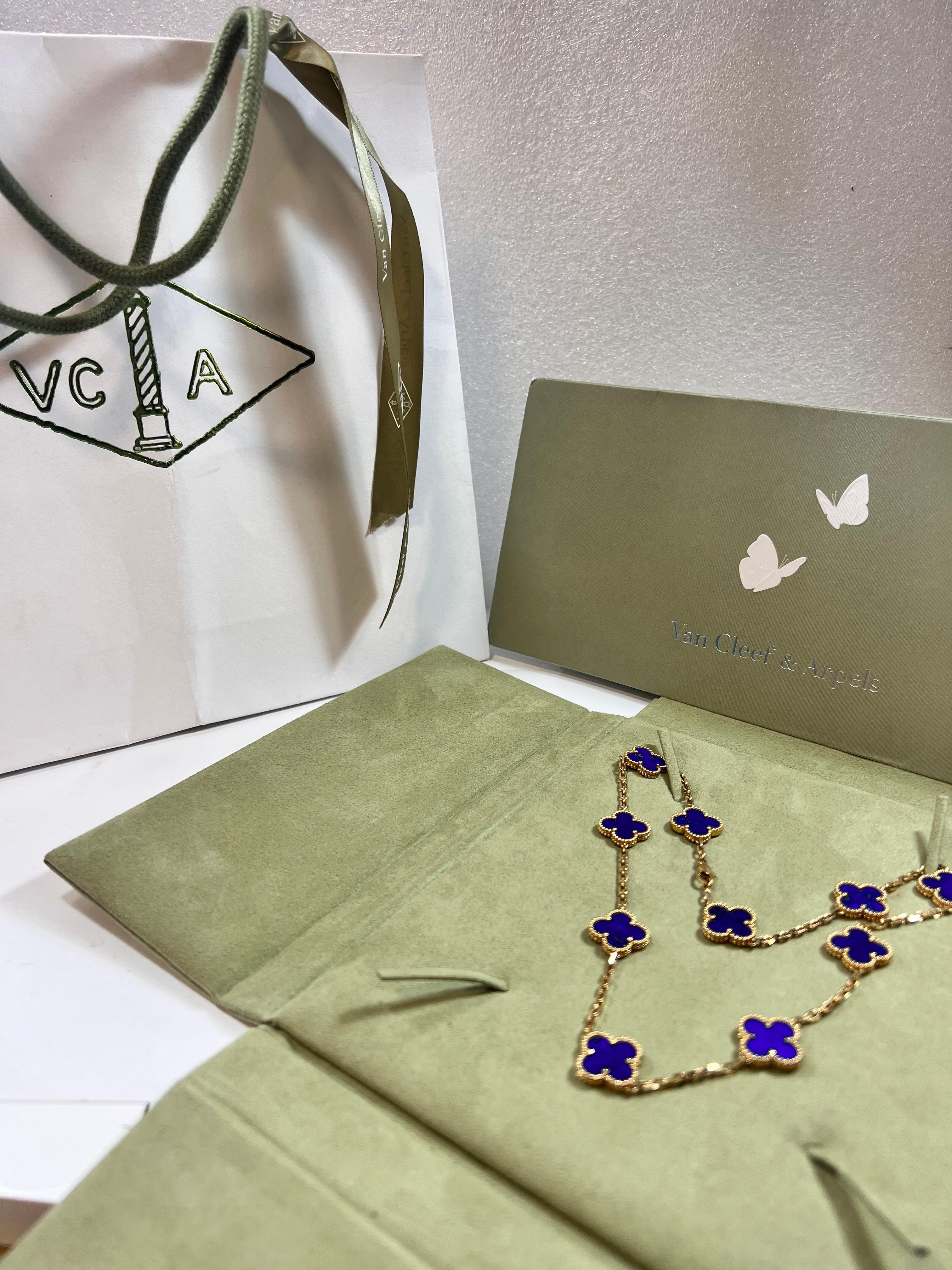 Vintage and out of production Van Cleef & Arpels necklace is crafted in 18k yellow gold and features 10 lucky clover motifs inlaid with lapis lazuli in round bead settings. Made in France circa 2000. Measurements: 0.59